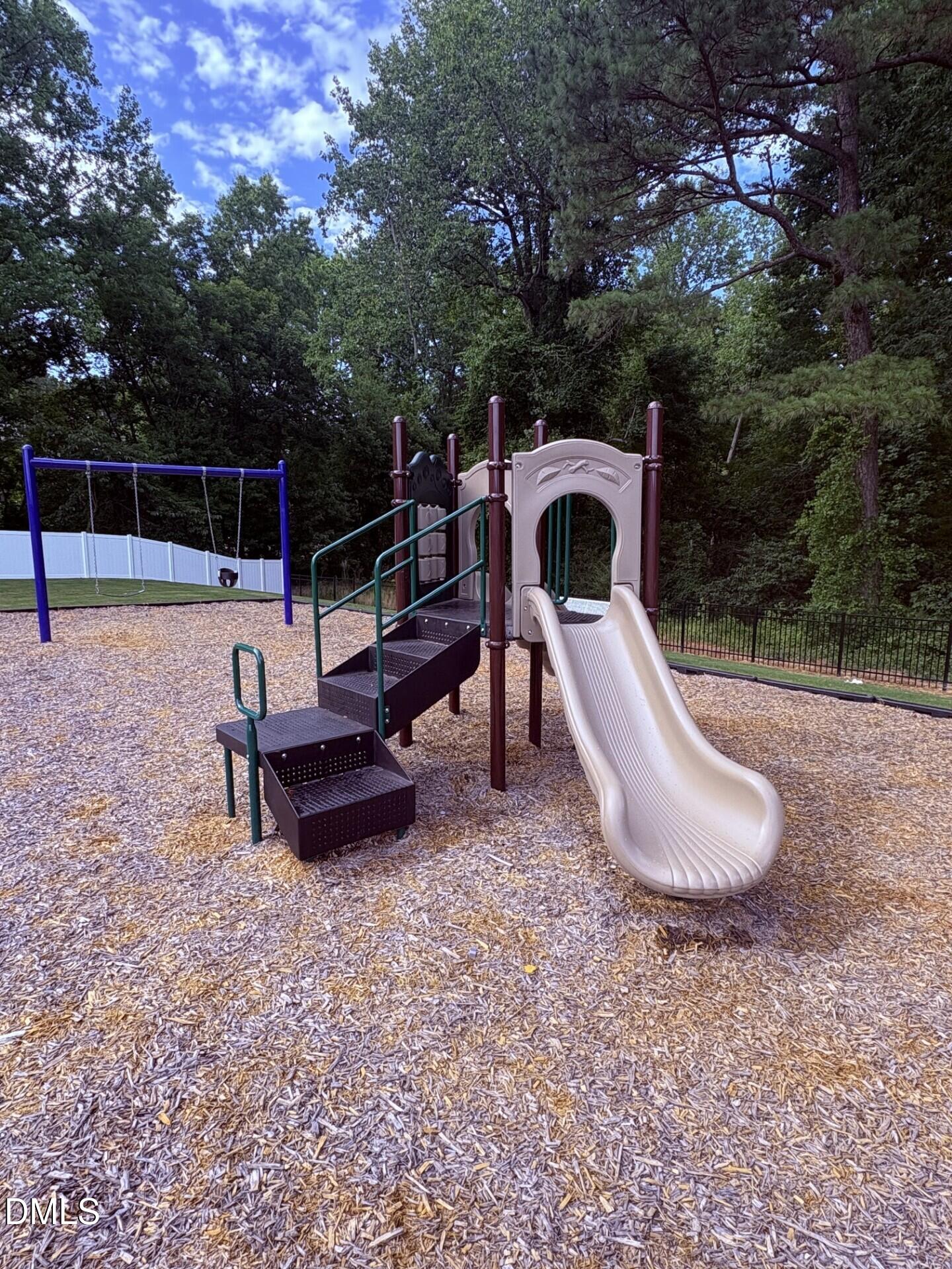 Community playground with slide and swing set at Woodland Crossing in Zebulon, North Carolina.