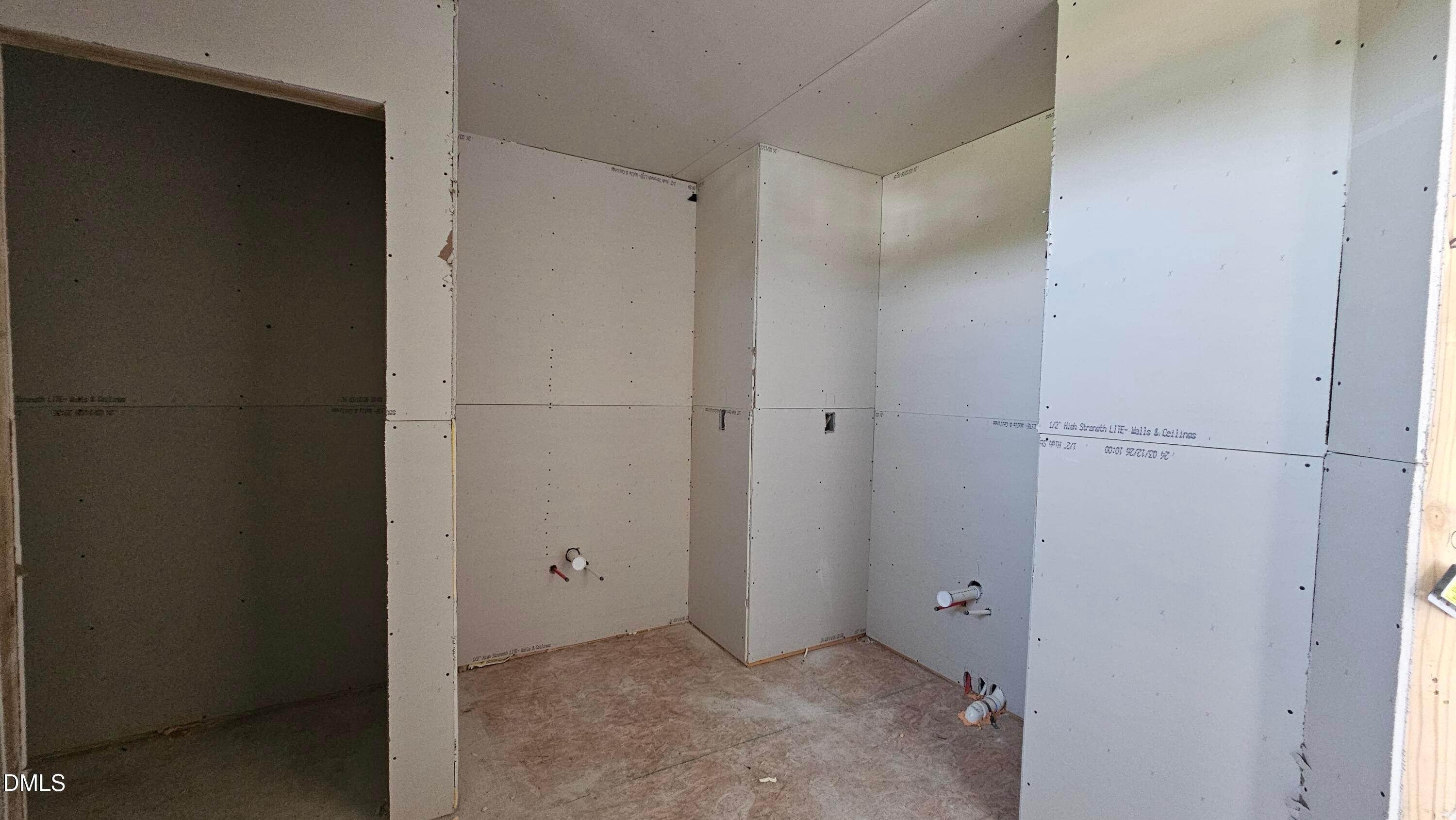 Unfinished bathroom with drywall and plumbing rough-ins in The Graham floor plan at Springvale, Fuquay-Varina, NC.