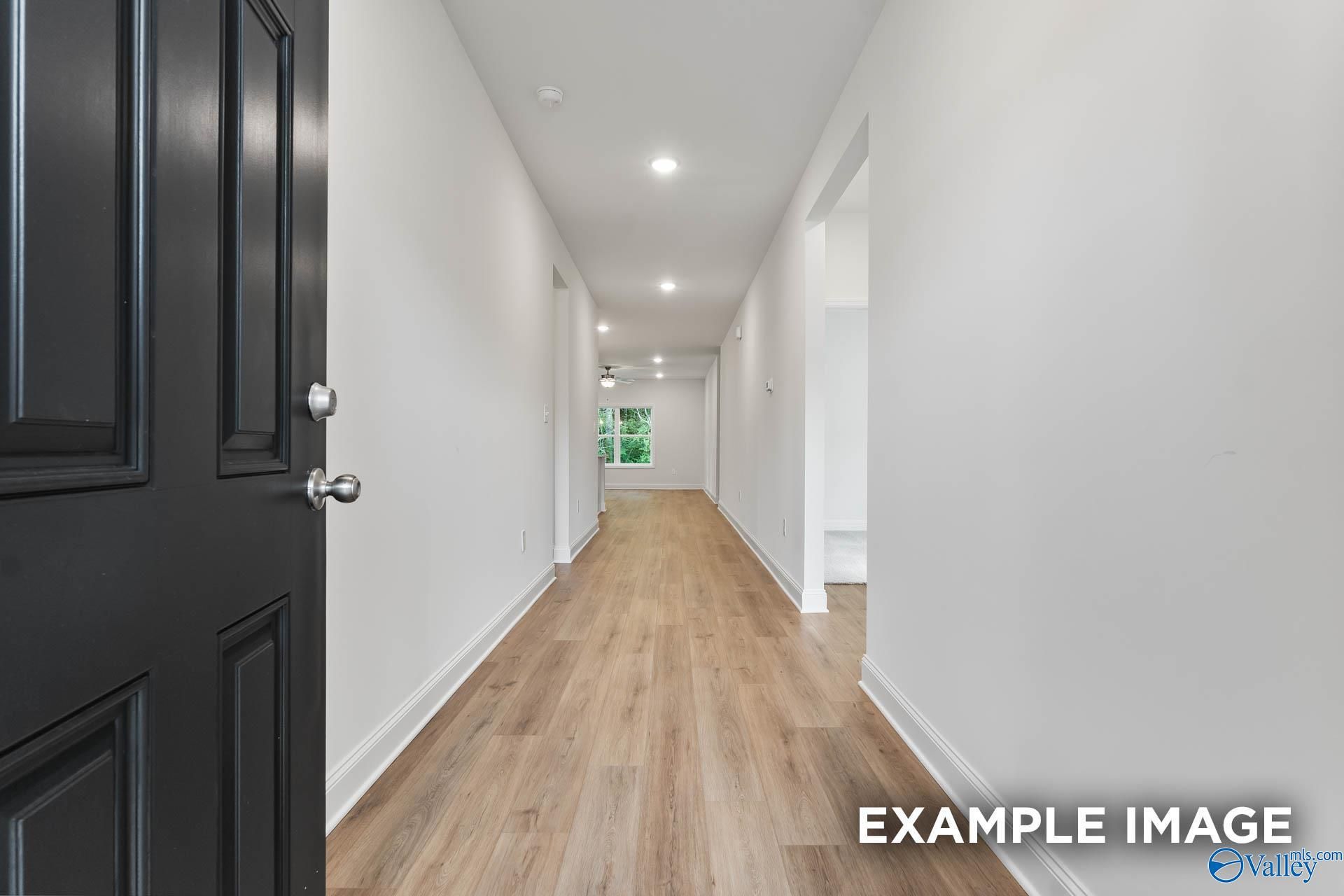 Open entryway hallway with light hardwood floors, white walls, and recessed lighting in The Daphne V 4-bedroom home, Athens, Alabama