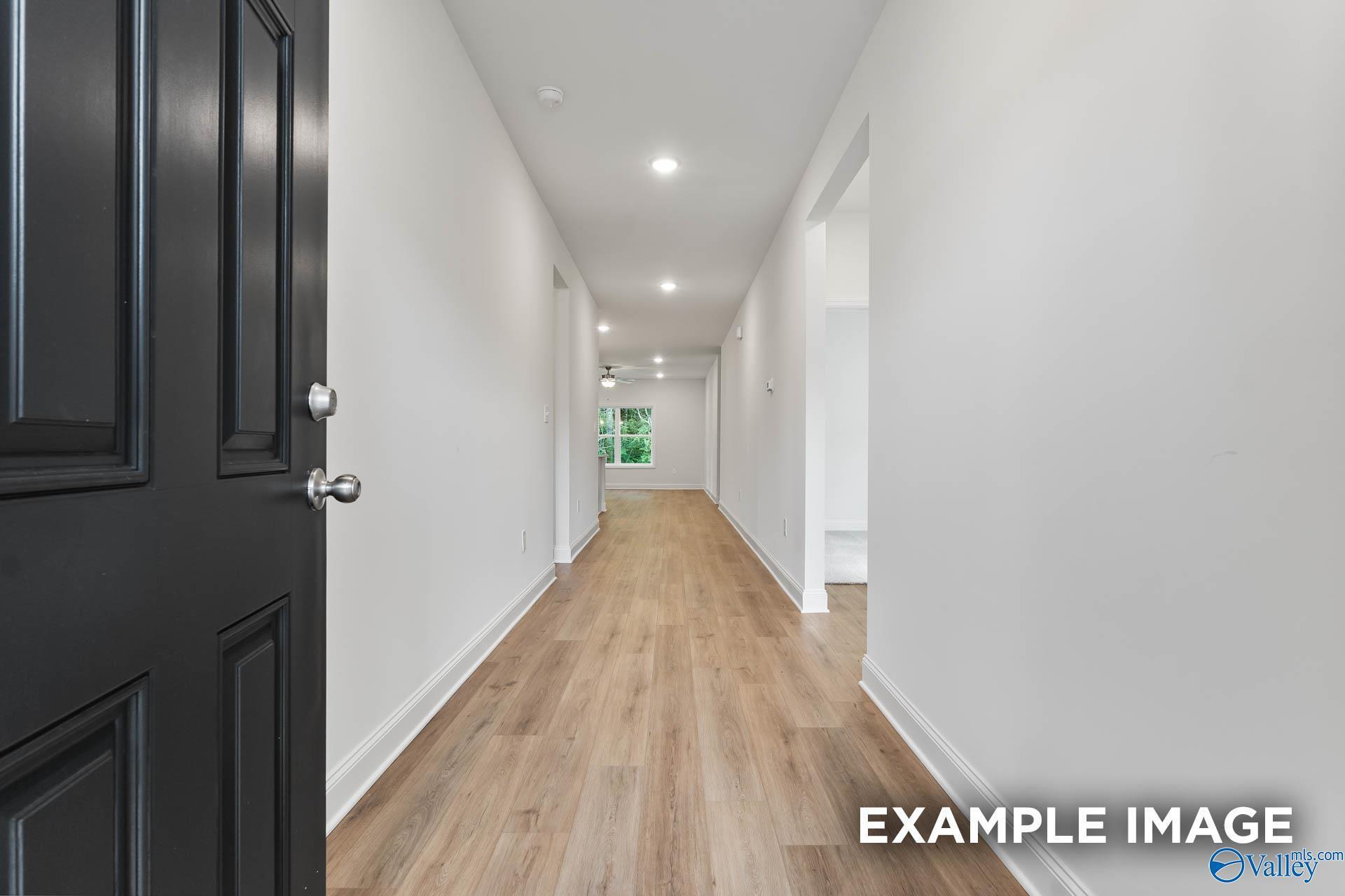 Open entryway hallway with light hardwood floors, white walls, and recessed lighting in The Daphne V 4-bedroom home, Athens, Alabama