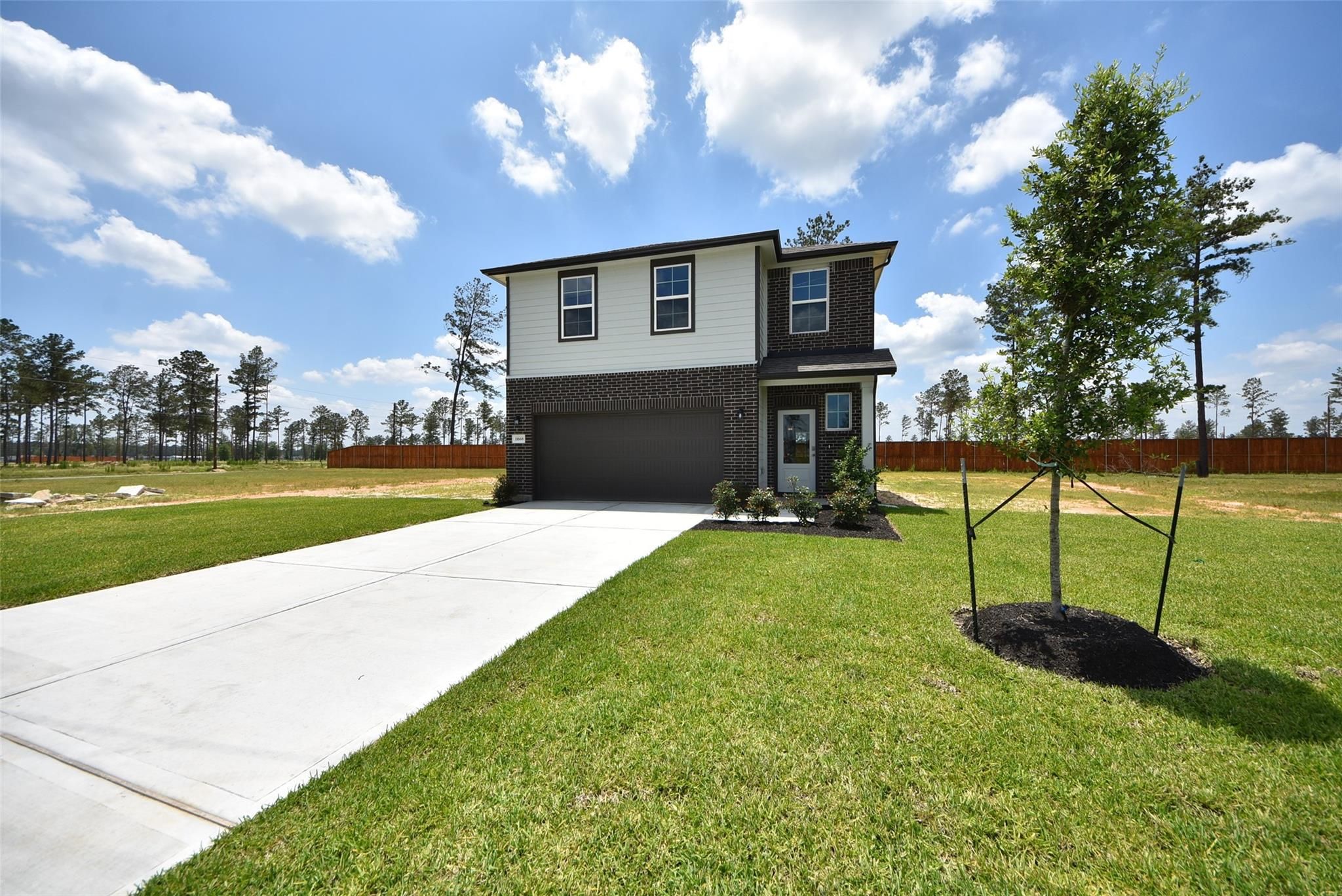 Two-story Davidson Homes Blanco F floor plan with 2-car garage in Spring Branch Crossing, Conroe, Texas.