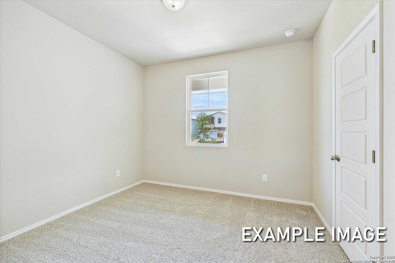 Empty secondary bedroom featuring beige walls, carpeted floor, and large window in Davidson Homes The Comal B, Agave, San Antonio, Texas