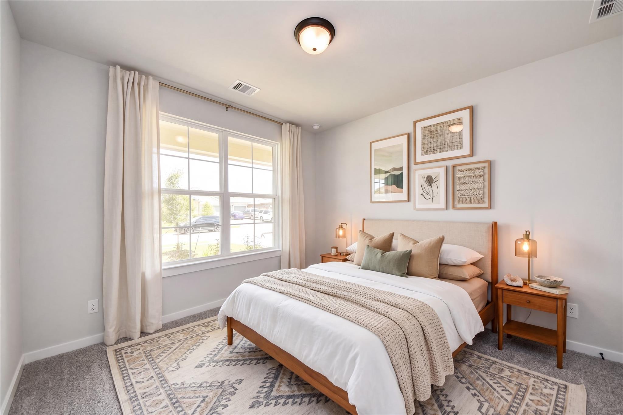 Bright, modern bedroom with neutral decor in The Everett C floor plan at River Ranch Meadows, Dayton, Texas.