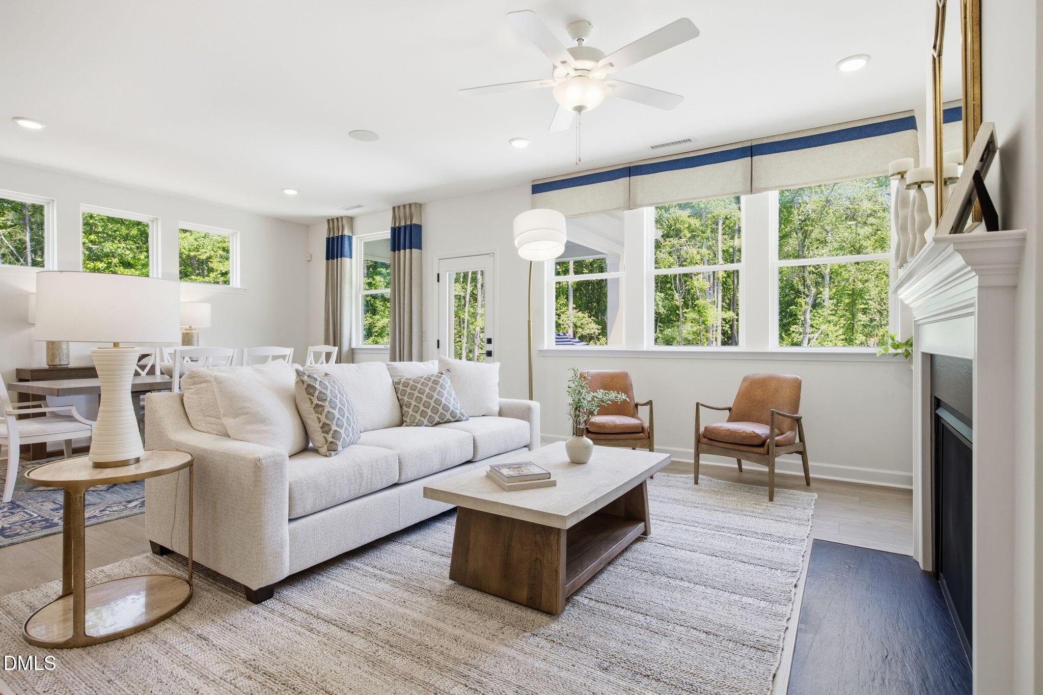 Bright open-concept living room with fireplace in The Ashport M floor plan at Wendell Ridge, Wendell, North Carolina.