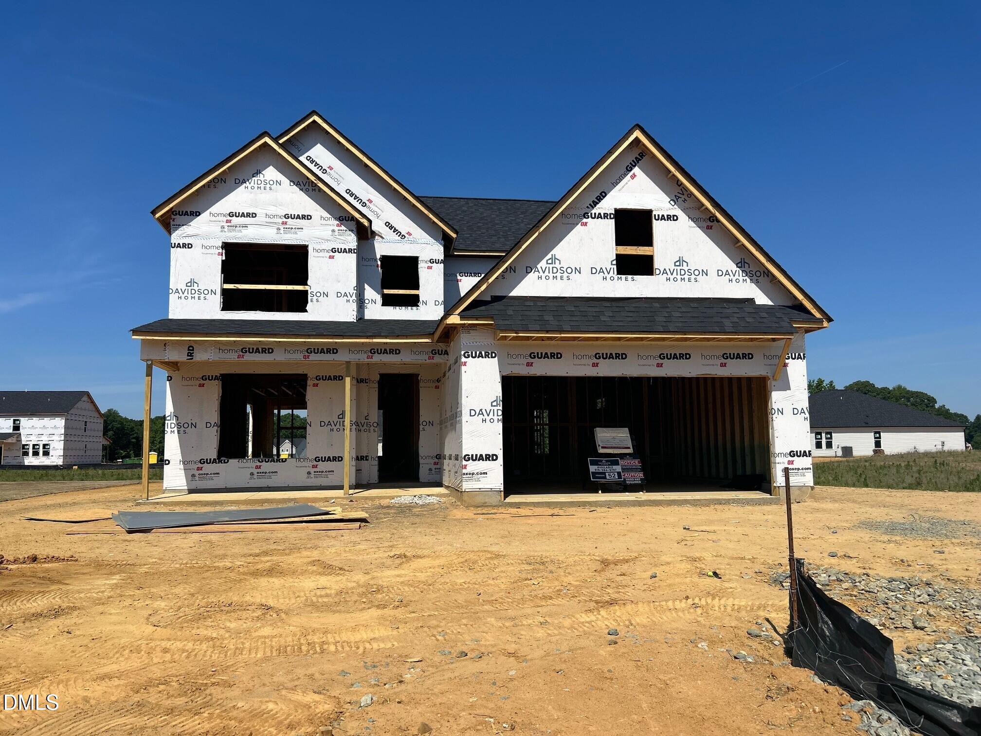 New construction of Davidson Homes The Ash B floor plan with 2-car garage in Retreat at North Main, Lillington, NC.