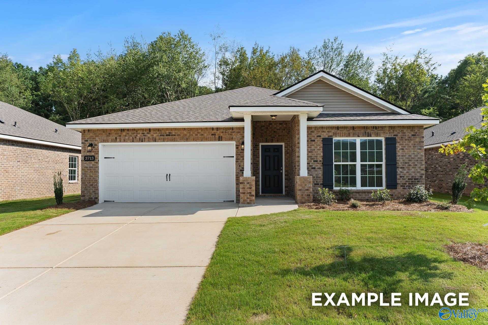 Brick-front single-story 4-bedroom home with 2-car garage, covered porch, and lush lawn in Heritage Lakes, New Market, Alabama - Davidson Homes Daphne