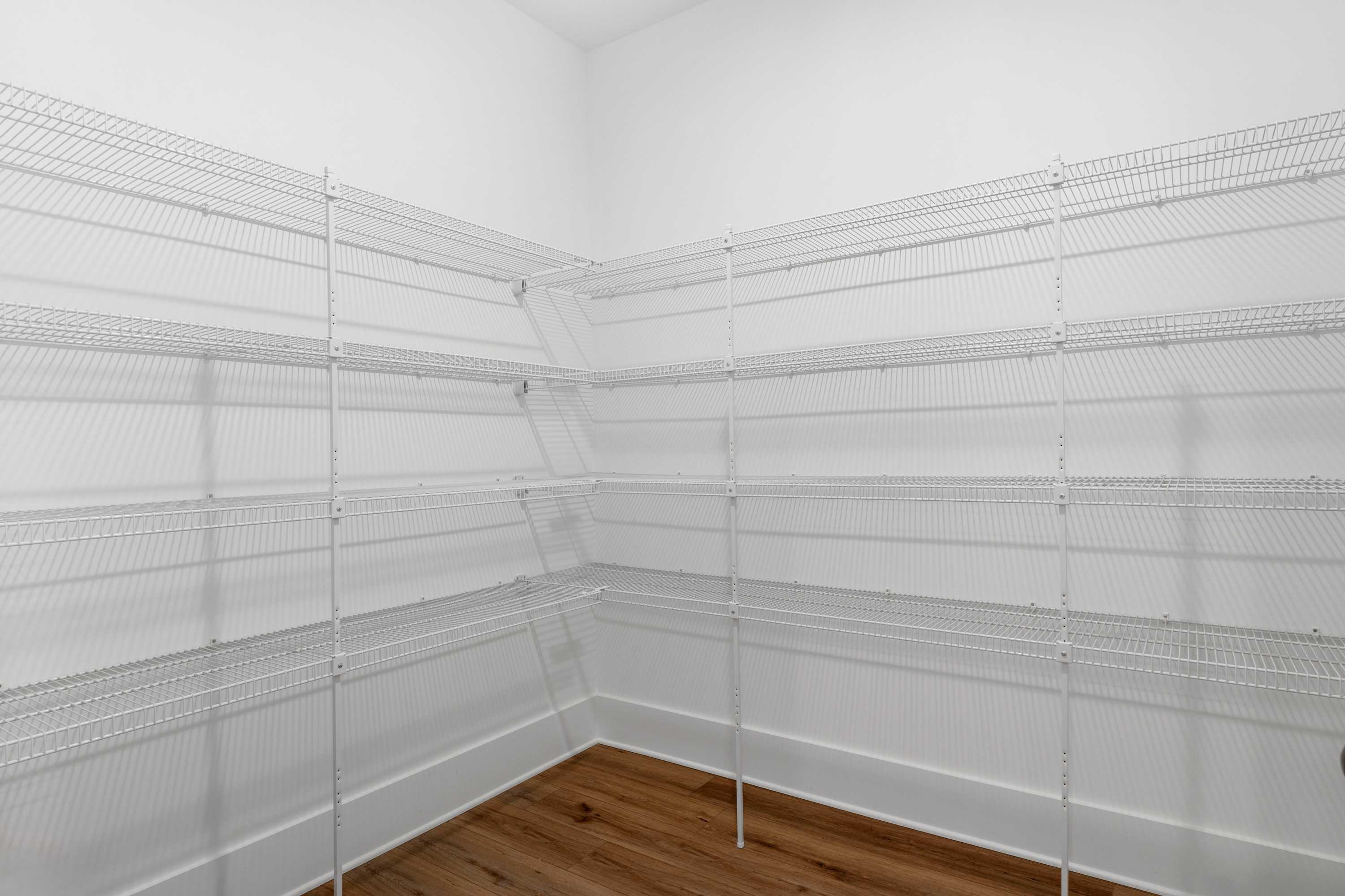 Spacious corner pantry with white wire shelving in Briercreek home, Meridianville Alabama by Davidson Homes