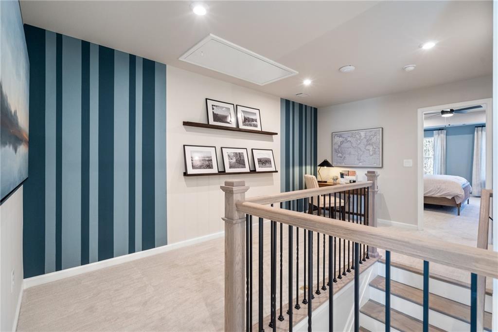 Upstairs loft with navy striped accent wall, floating shelves, desk nook overlooking master bedroom in Davidson Homes The Marion B, Kennesaw GA