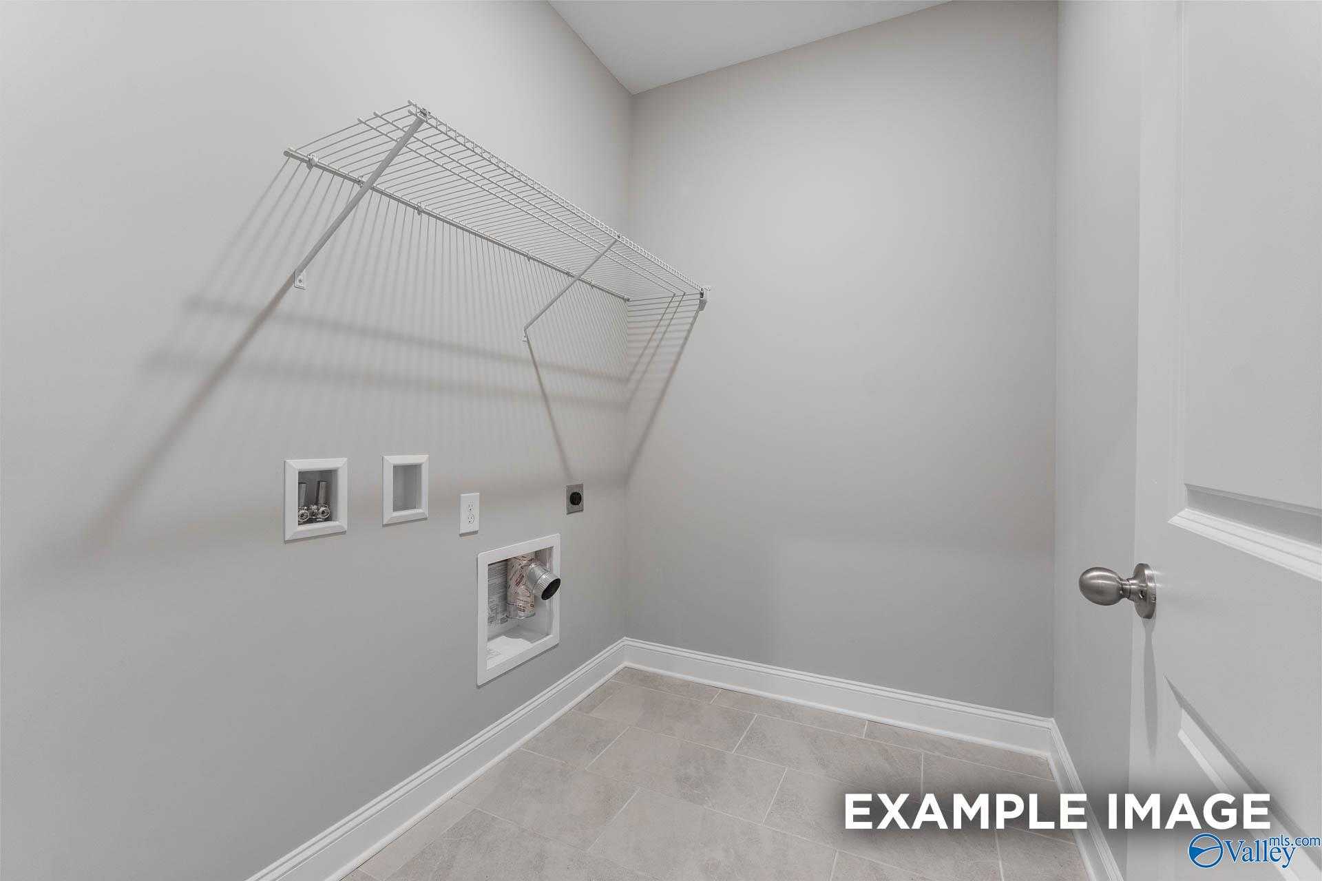 Modern laundry room featuring wire drying rack, dryer vent, and outlets in Davidson Homes The Rockford D, Hazel Green, AL