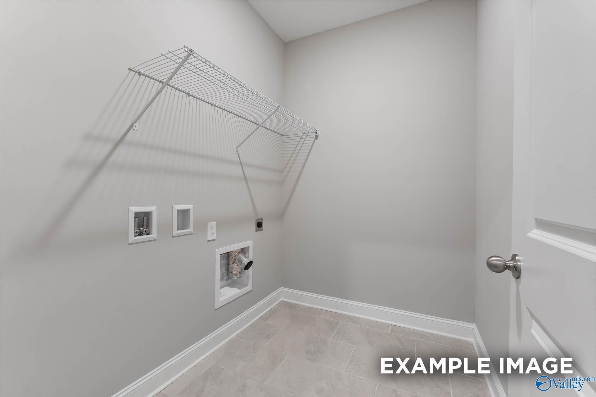 Functional laundry room with wire drying rack, outlets, and tile floor in Davidson Homes The Rockford, Madison, Alabama