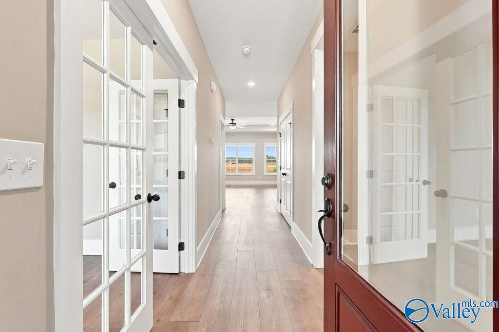 Bright foyer hallway with wood-look flooring leading to the main living area in The Rockford floor plan, Cain Park, Hartselle.