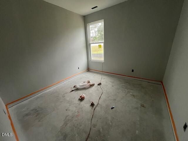 Unfinished bedroom under construction with window overlooking yard in Davidson Homes The Daphne C, Wellers Knoll, Lillington, NC