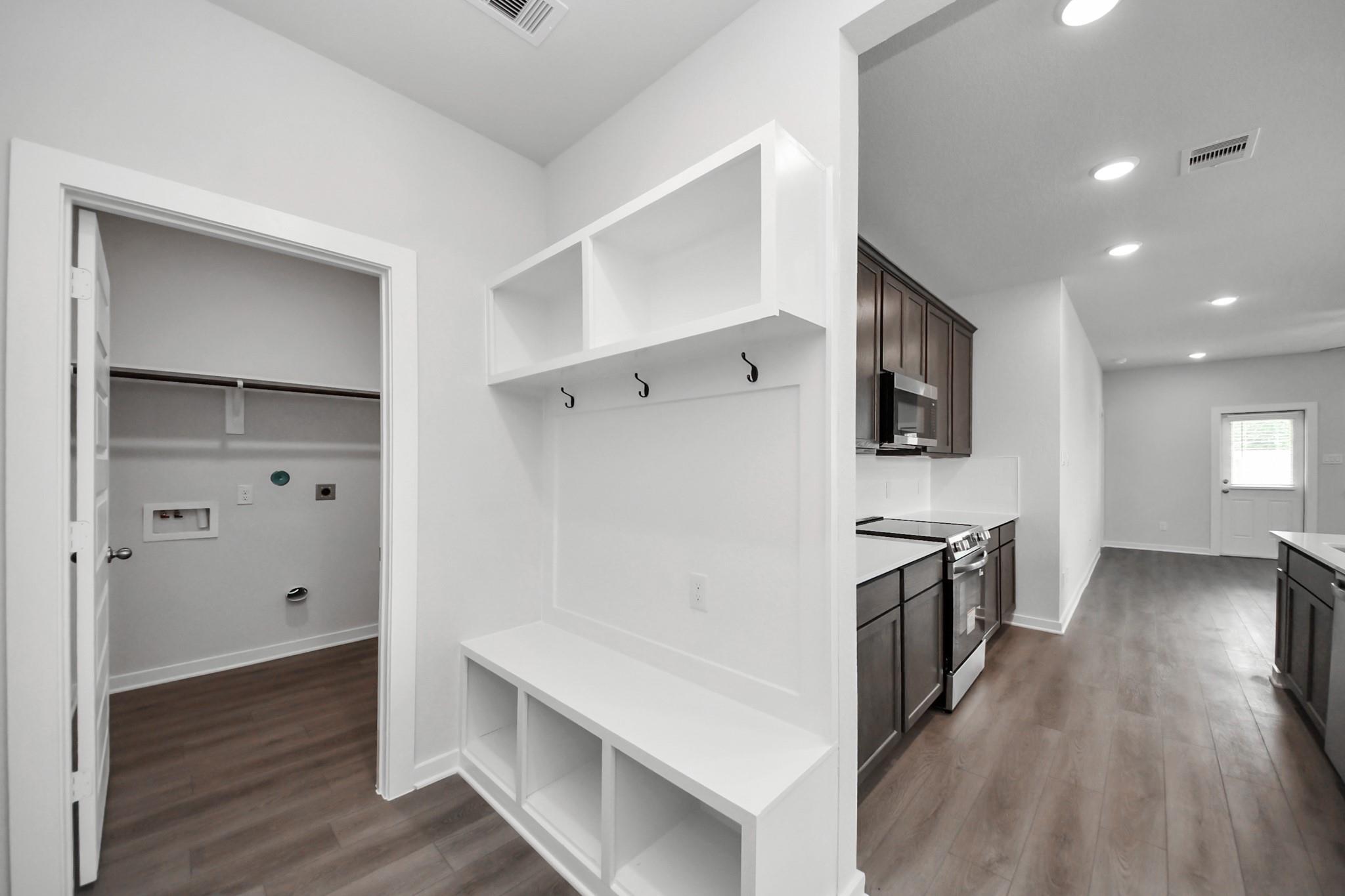 Mudroom bench with storage and laundry room in The Brazos F floor plan by Davidson Homes in Liberty Estates, Cleveland, TX.