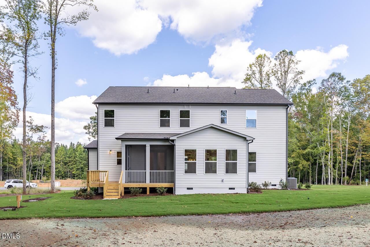 Rear exterior of 2-story Davidson Homes Crawford D plan with screened porch and yard in Rockport, Wake Forest, NC