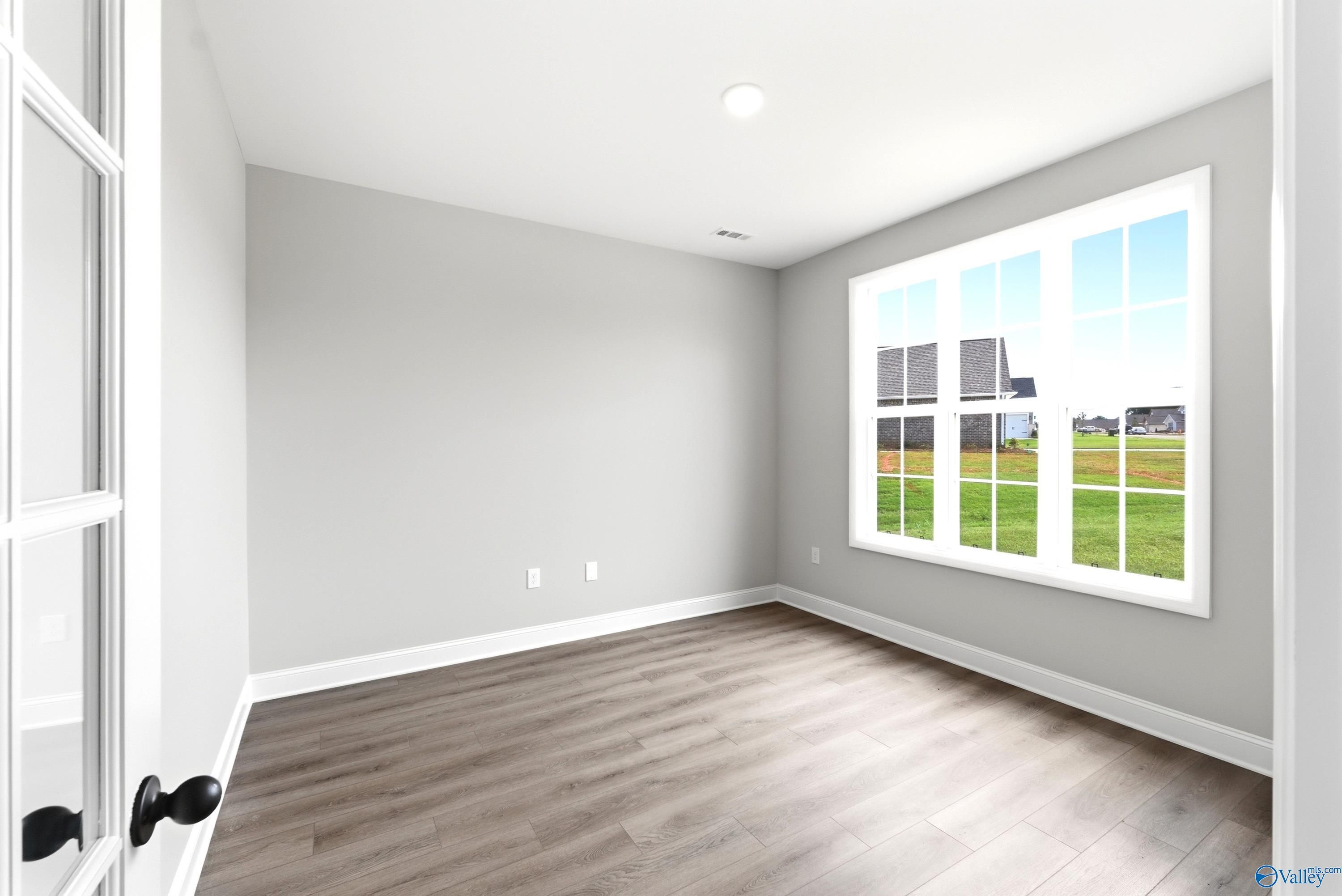 Bright home office or flex room with wood-look flooring in The Finleigh floor plan at Riverton Preserve, Huntsville.