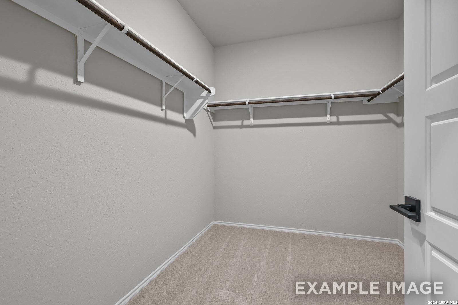 Walk-in closet with built-in shelving in The Glenwood E floor plan by Davidson Homes in Royal Crest, San Antonio.