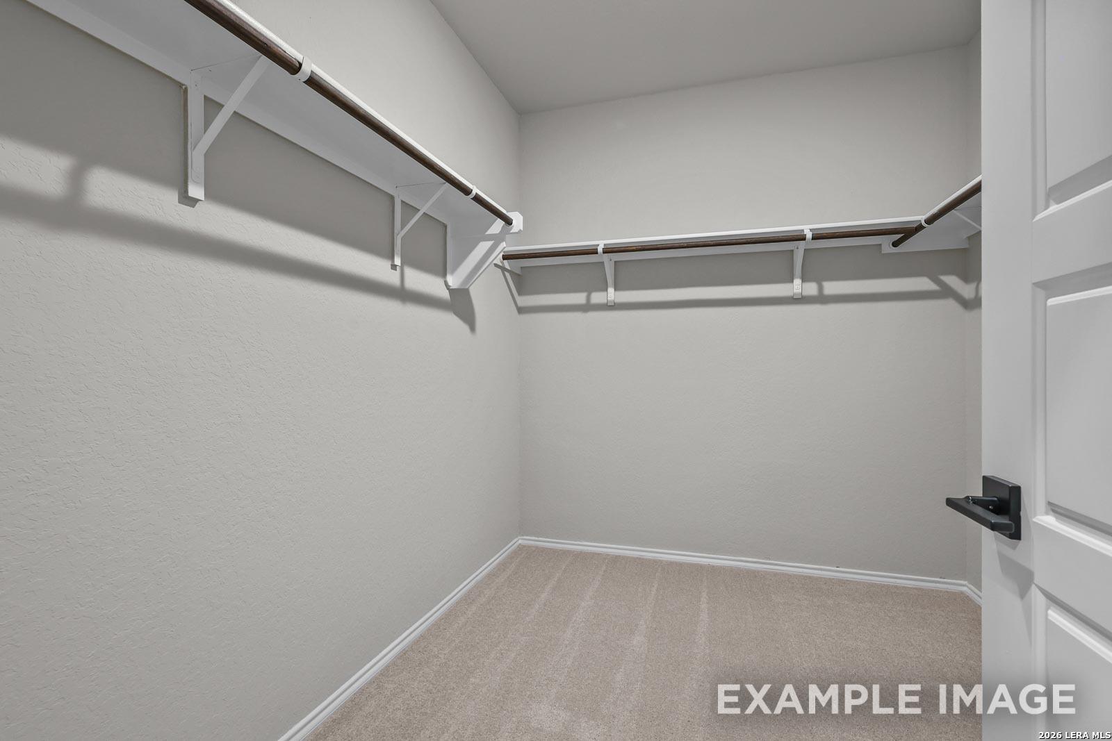 Walk-in closet with built-in shelving in The Glenwood E floor plan by Davidson Homes in Royal Crest, San Antonio.