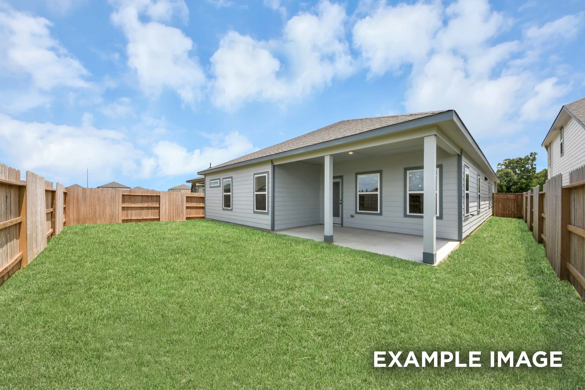 Spacious backyard and covered patio of The Sorrento single-family home in Crosby, Texas, featuring a fenced-in grassy lawn.