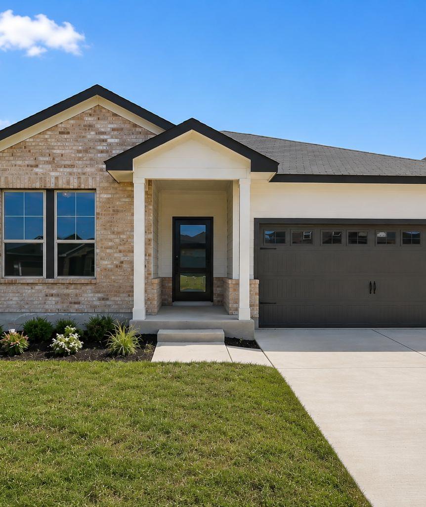 Modern kitchen with dark cabinets, granite island, stainless steel appliances at Hannah Heights in Seguin, Texas