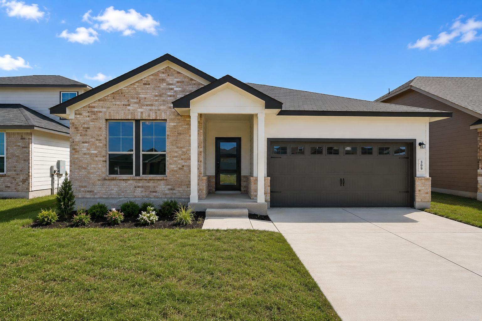 Modern kitchen with dark cabinets, granite island, stainless steel appliances at Hannah Heights in Seguin, Texas