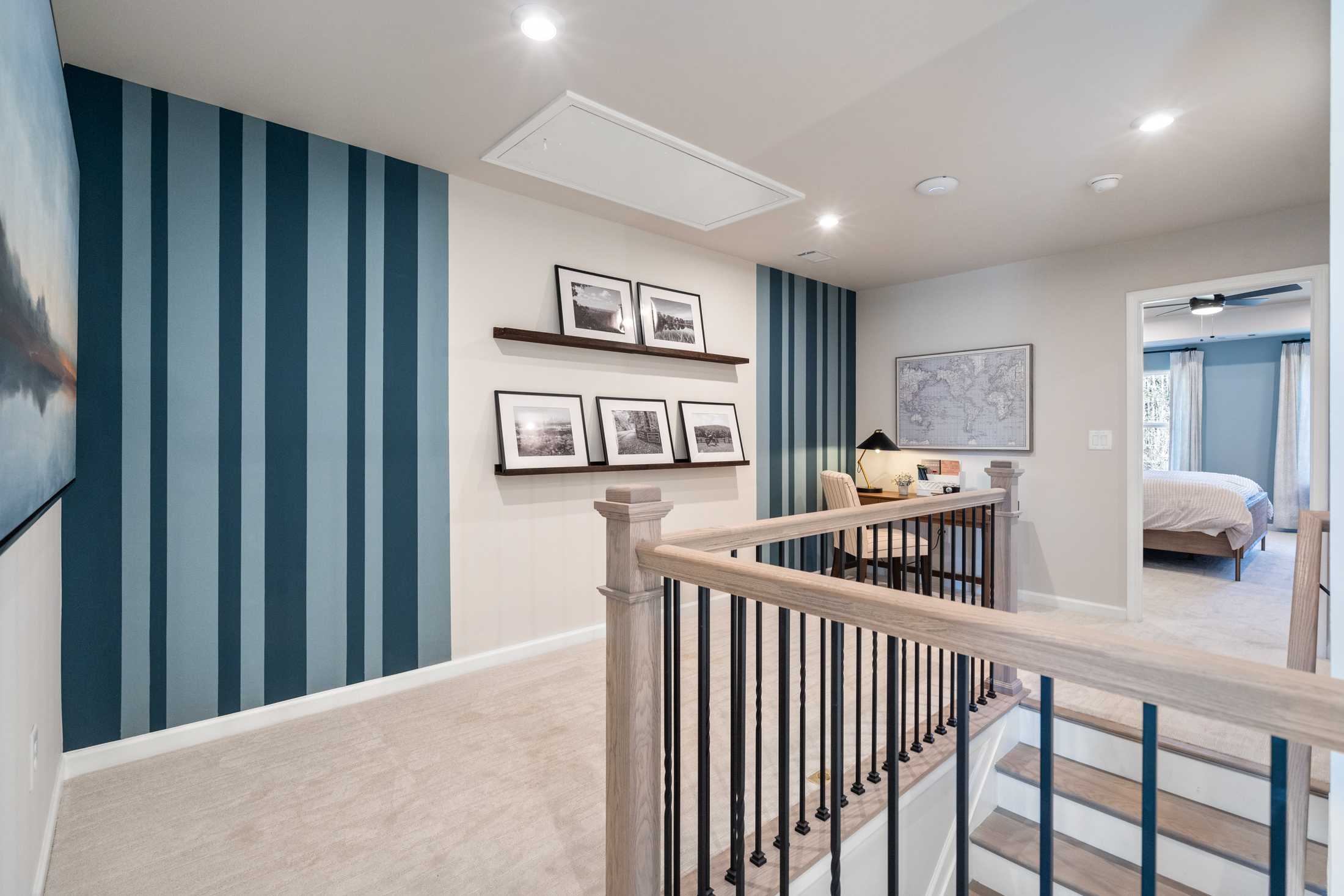 Spacious loft home office at The Village at Shallowford in Kennesaw Georgia with navy striped accent wall shelves desk and bedroom overlook