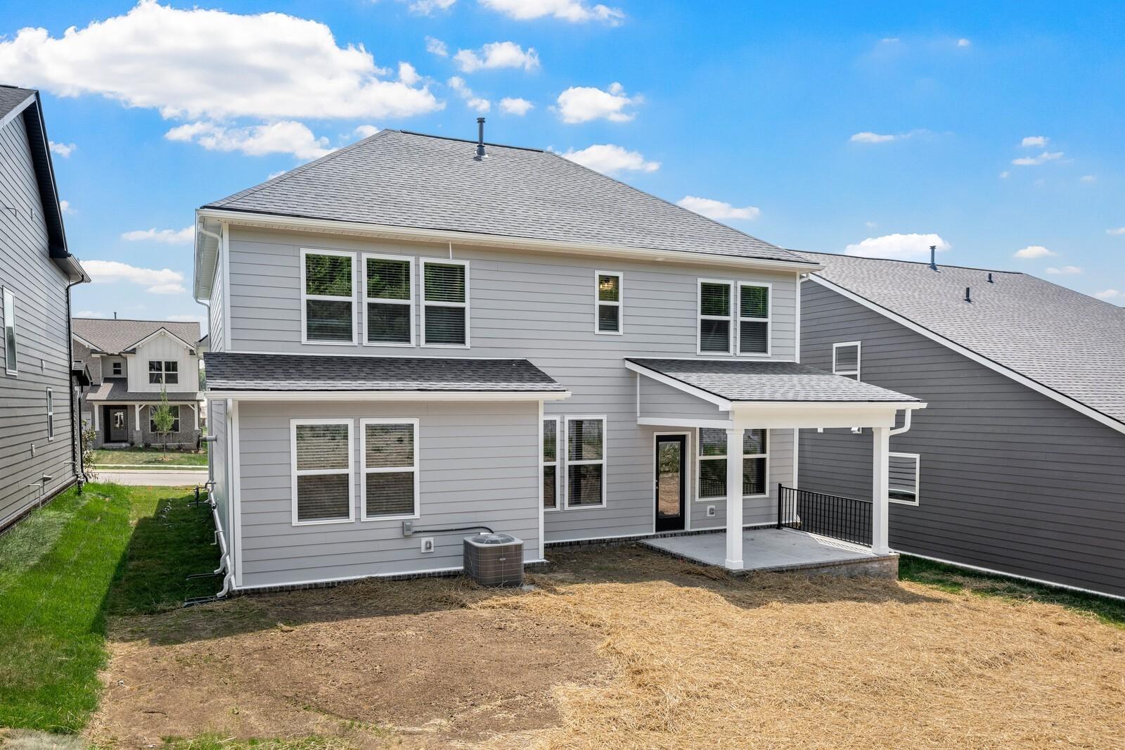 Rear exterior of The Willow floor plan by Davidson Homes with a covered patio in Woods Crossing, Gallatin, Tennessee.