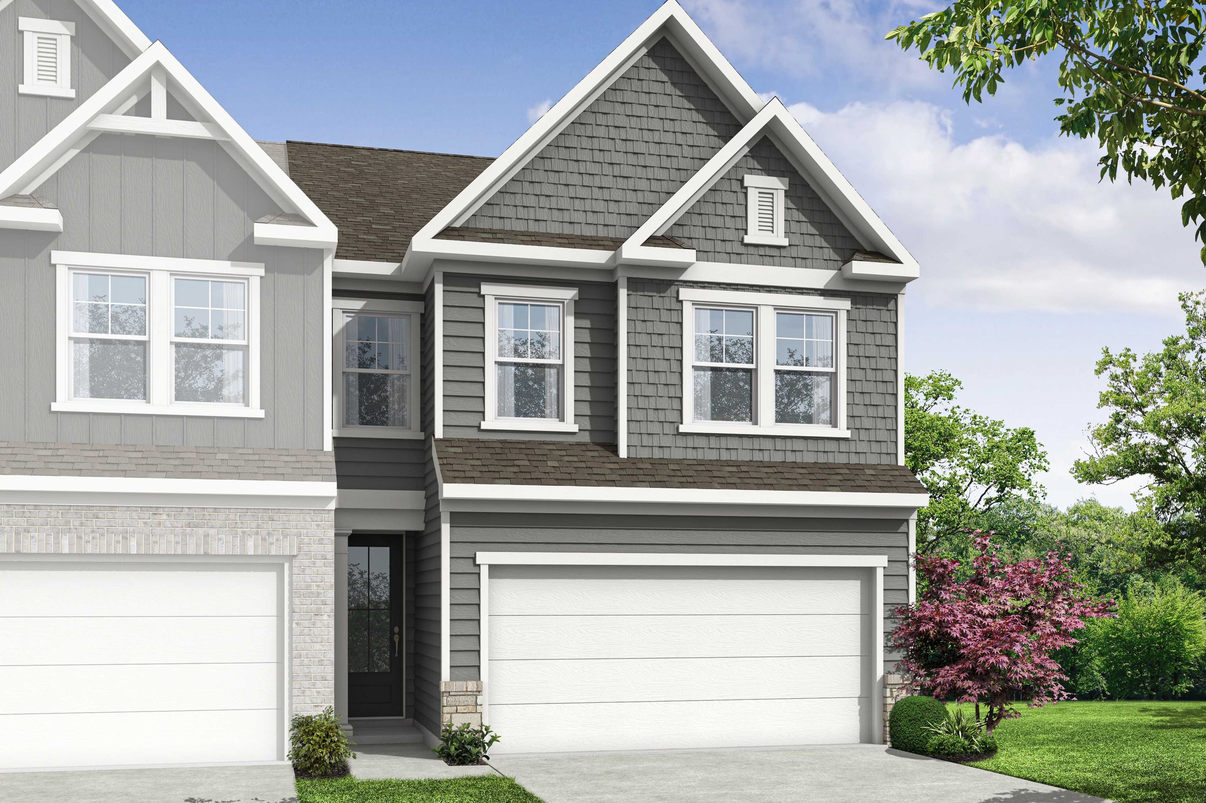 Modern two-story home exterior at Lake Shore in Winder, Georgia with gray siding, attached garage, and lush landscaping