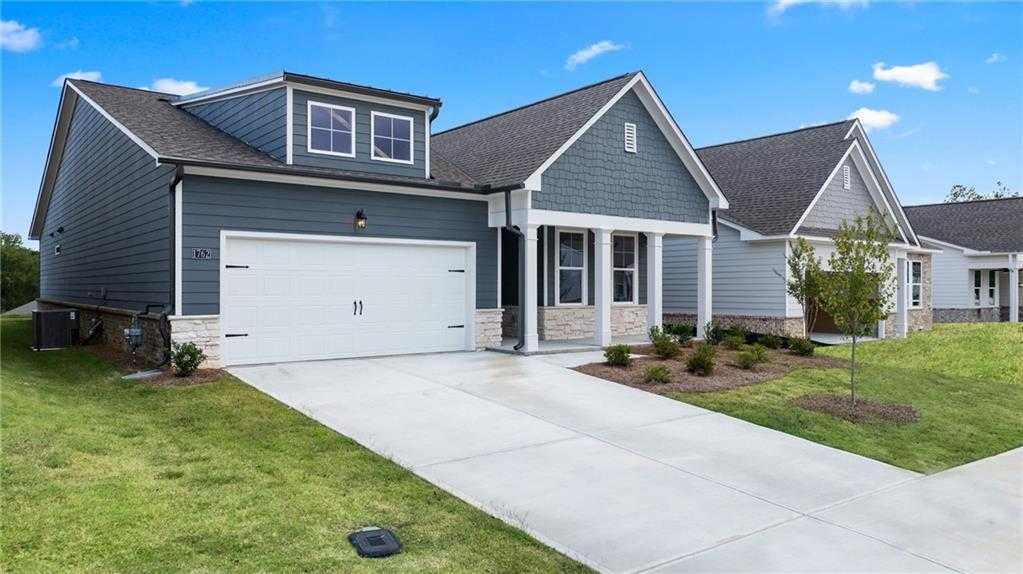 Modern gray single-story home with 2-car garage, driveway, and landscaped yard in Kelly Preserve, Loganville, Georgia by Davidson Homes