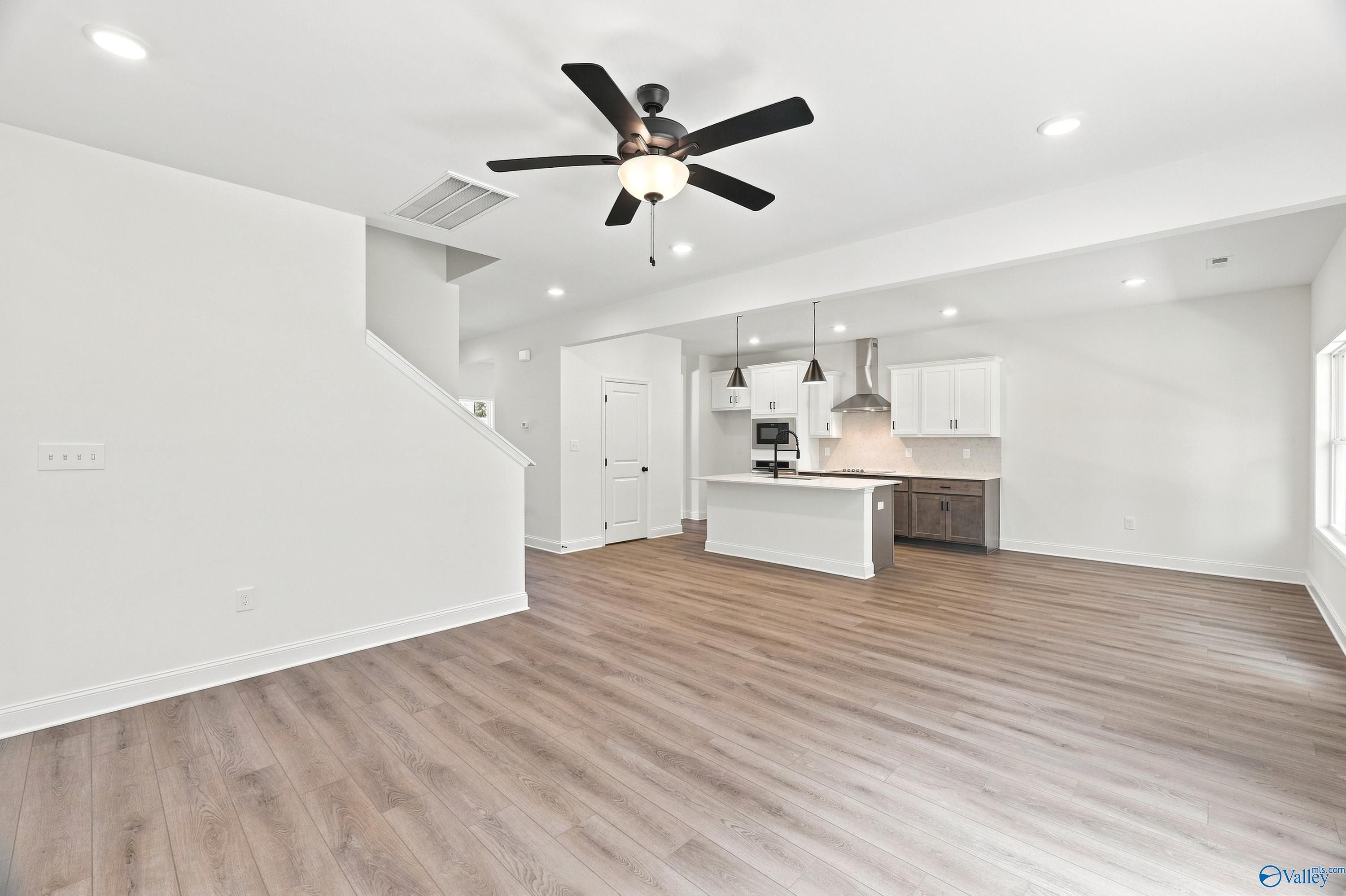 Open-concept living room and kitchen in The Shelby B floor plan by Davidson Homes in Jaguar Hills, Huntsville, Alabama.