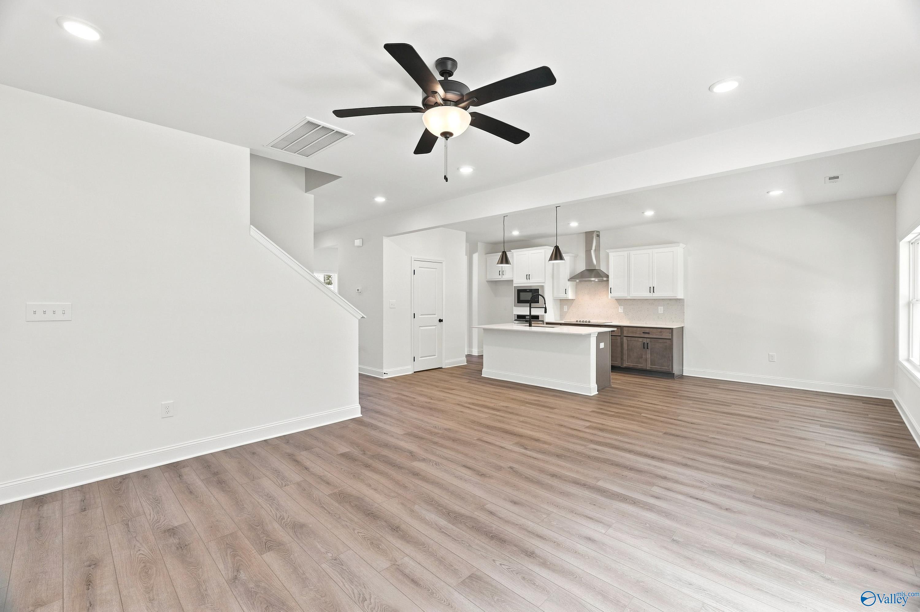 Open-concept living room and kitchen in The Shelby B floor plan by Davidson Homes in Jaguar Hills, Huntsville, Alabama.