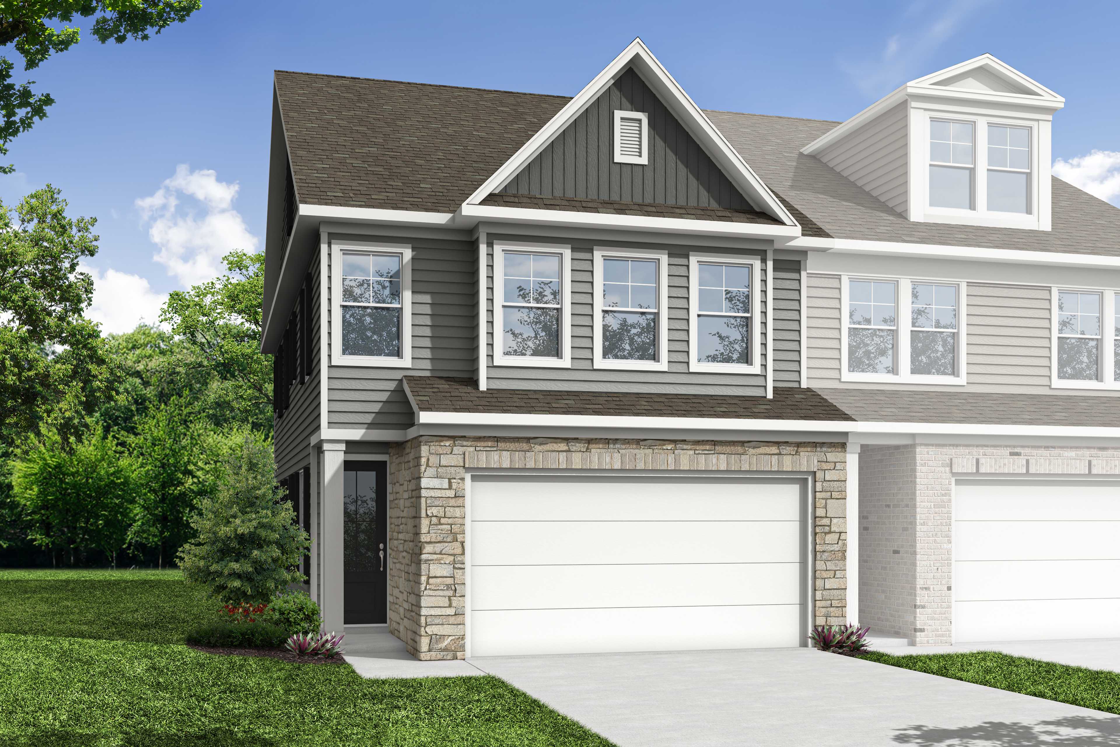 Modern two-story multi-family duplex The Wake D with gray siding, stone entry, dual garages, and lush landscaped yard in Cumming GA