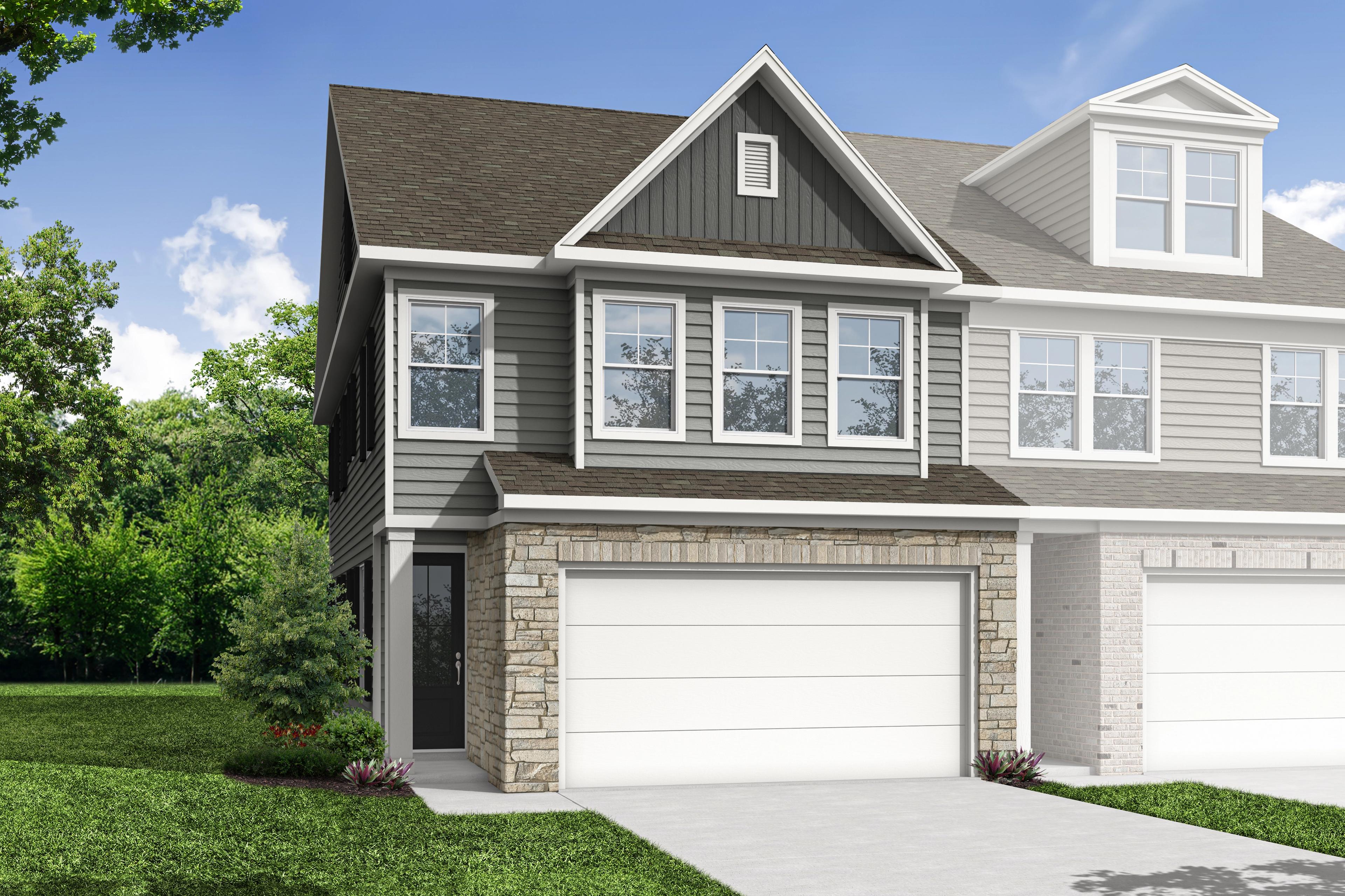 Modern two-story multi-family duplex The Wake D with gray siding, stone entry, dual garages, and lush landscaped yard in Cumming GA