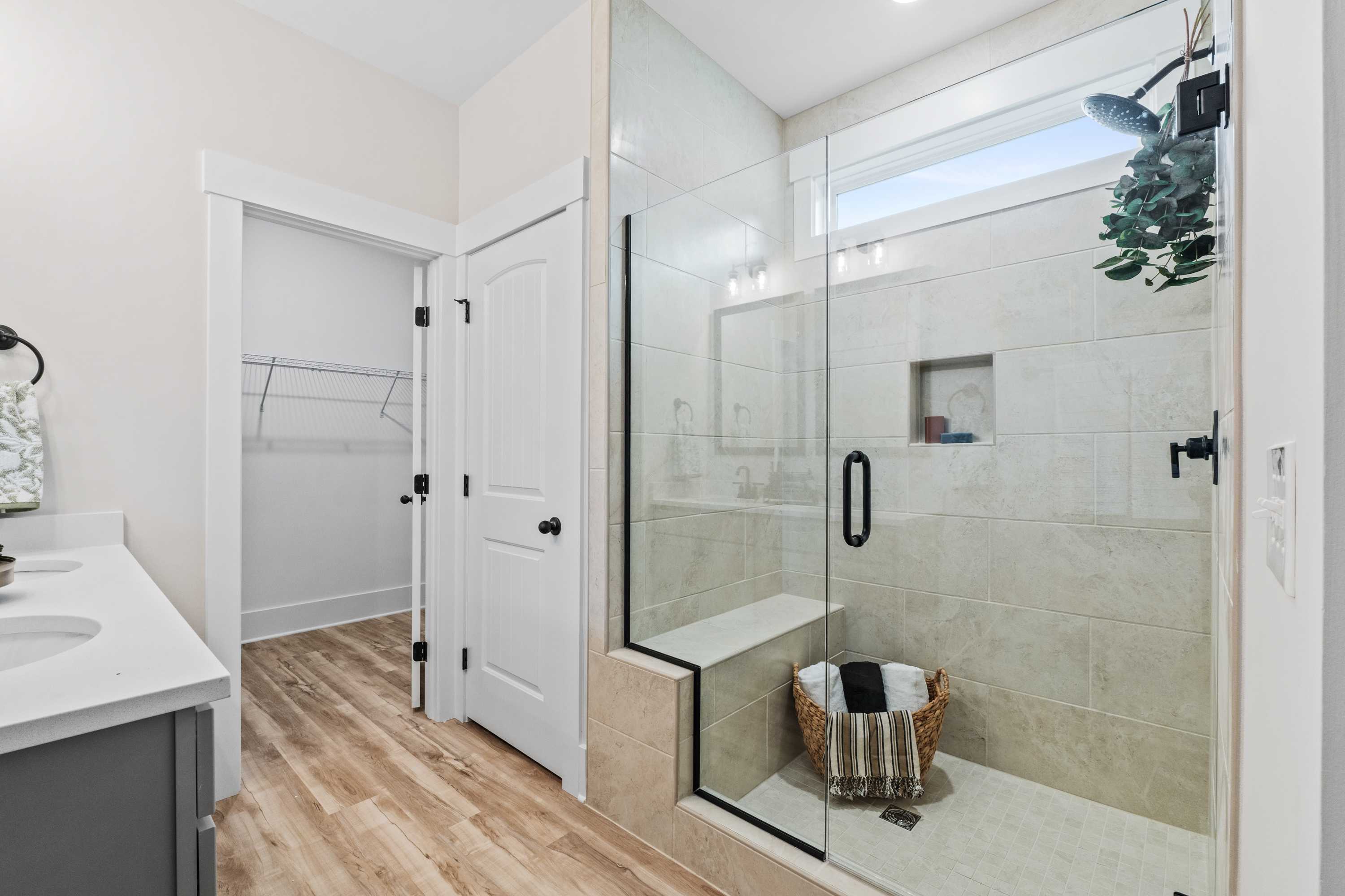 Spacious modern bathroom at Spragins Cove in Huntsville AL with glass shower, double vanity, hardwood floors