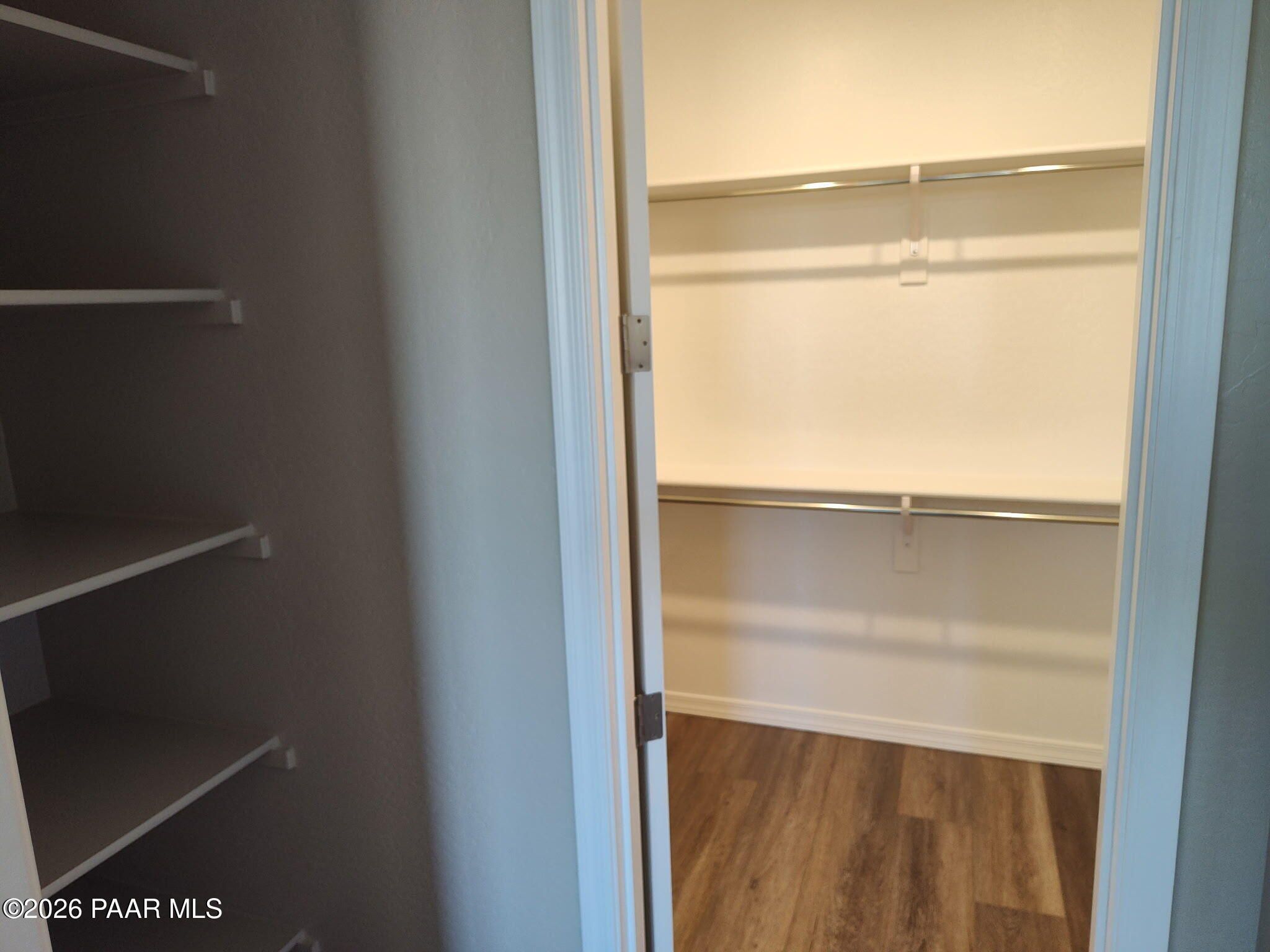 Walk-in closet with built-in shelving in The Inspiration C floor plan at North Ridge, Prescott Valley, Arizona.