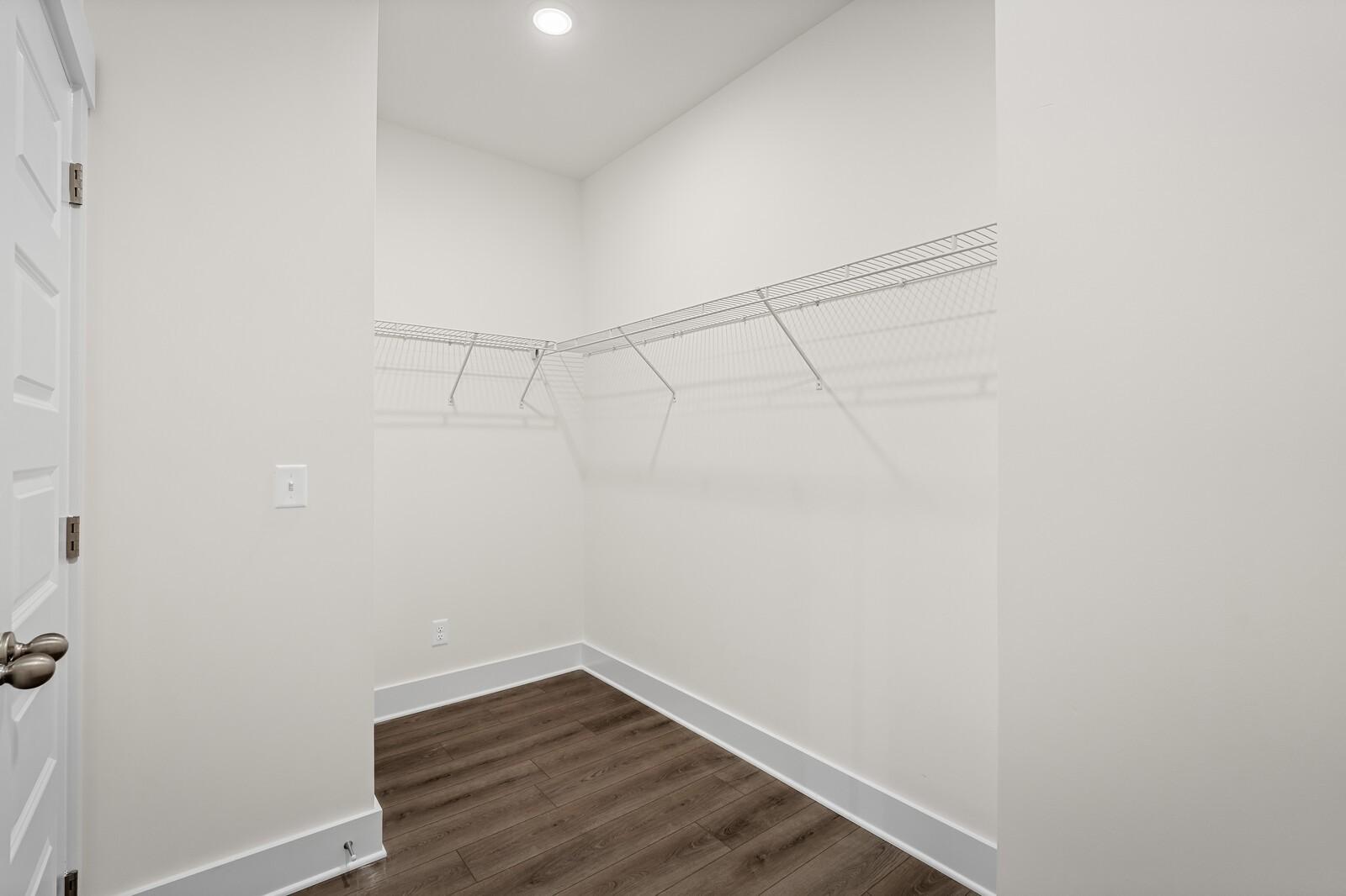 Spacious walk-in closet with wire shelving in The Ridgeport D floor plan by Davidson Homes in Mt. Juliet, Tennessee.