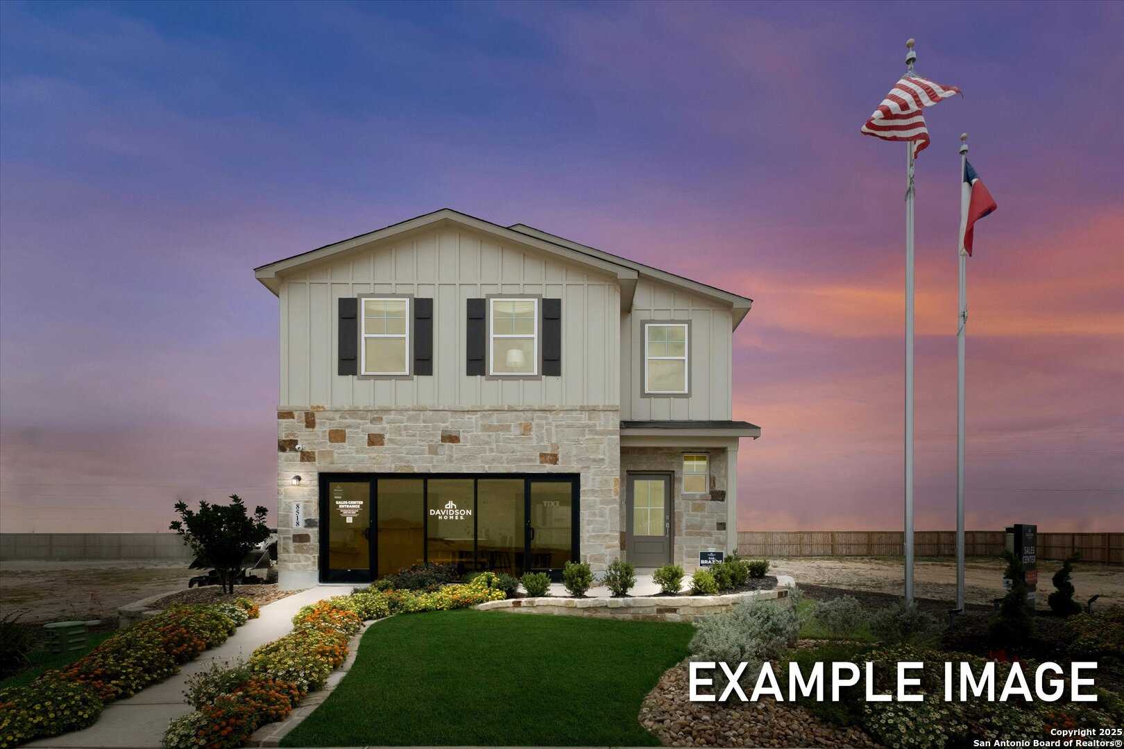 Modern two-story Brazos C home exterior with stone accents, lush landscaping, US and Texas flags at dusk in Agave, San Antonio by Davidson Homes