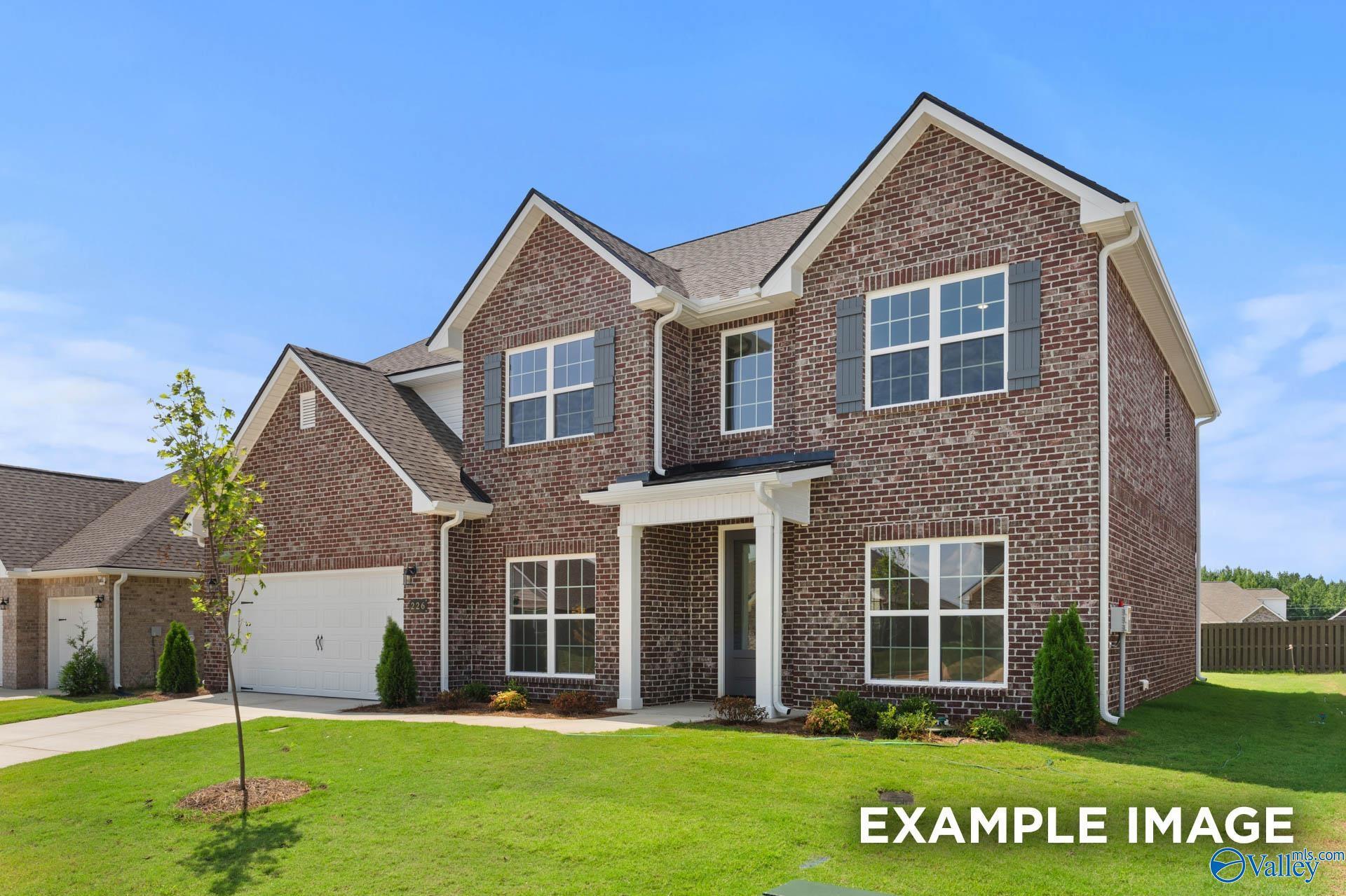 Two-story brick home with 2-car garage, front porch, and lush lawn in Pikes Ridge, Meridianville, Alabama - Davidson Homes The Madison A