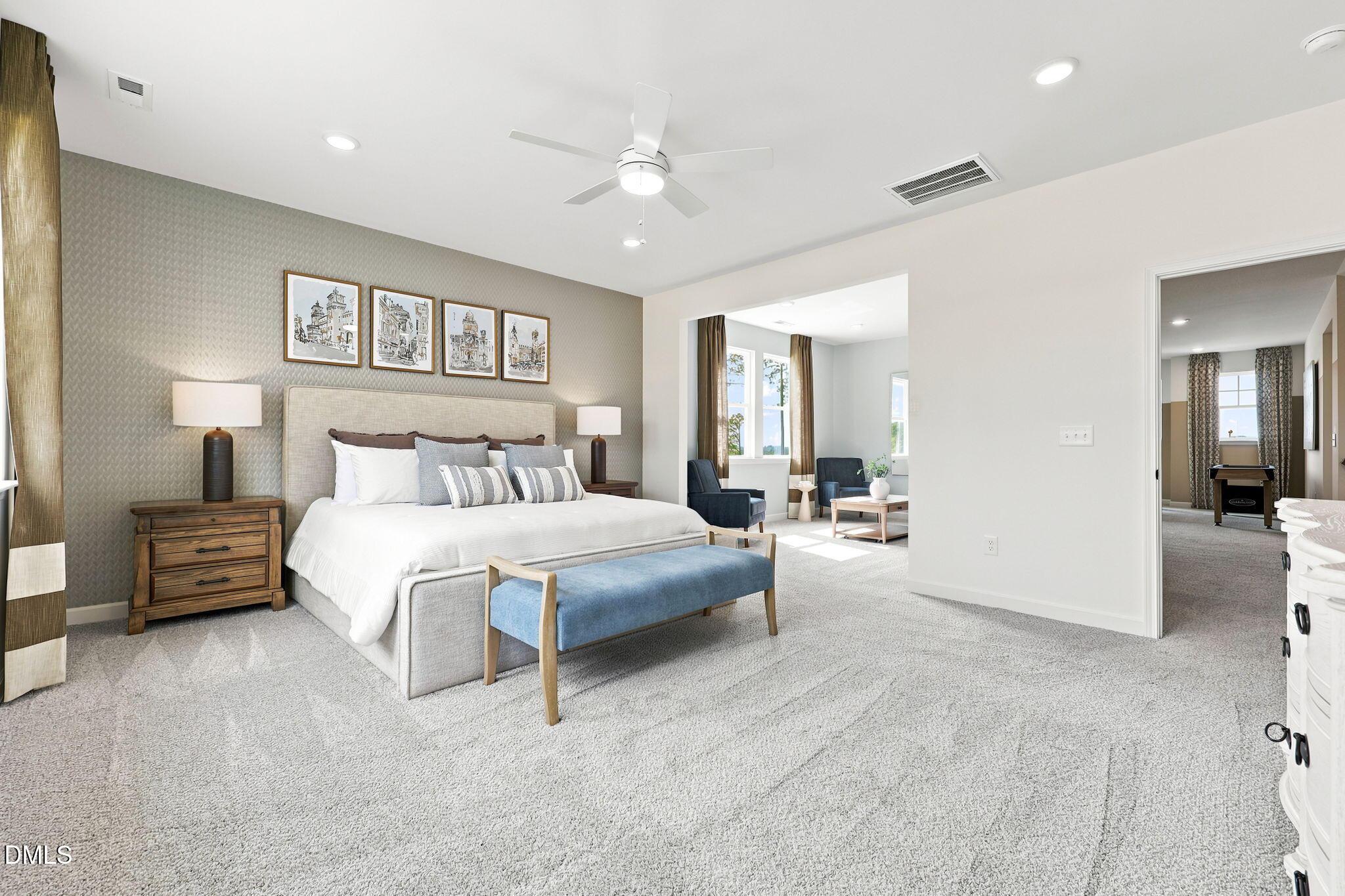 Spacious primary bedroom with sitting area in The Beech B floor plan at Addison West, Holly Springs, North Carolina.
