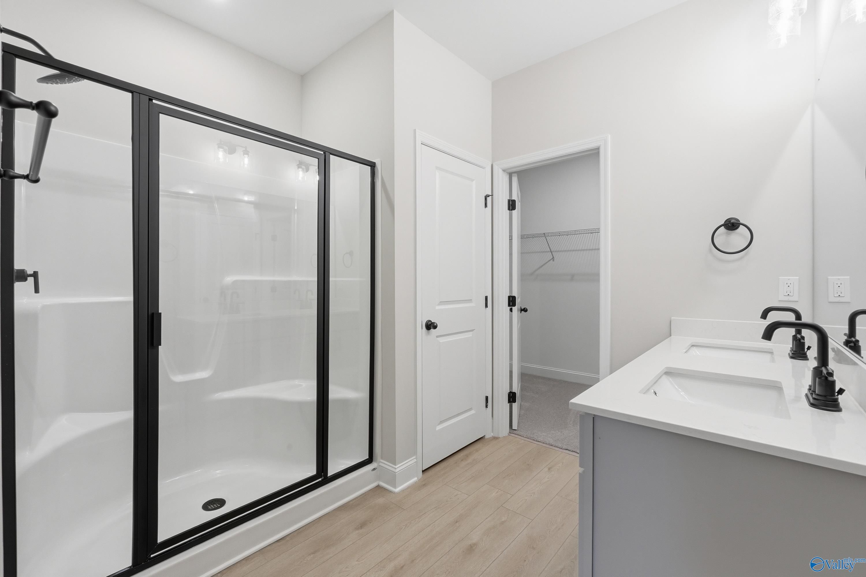 Modern master bathroom featuring glass shower enclosure and double vanity in Davidson Homes The Franklin C, New Market, Alabama