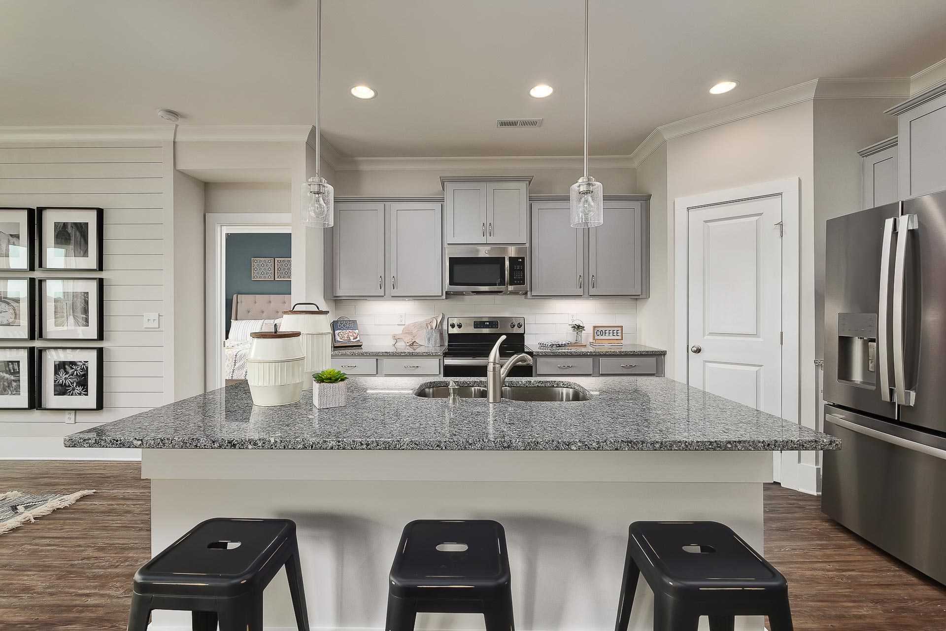 kitchen with gray cabinets and stainless steel appliances at The Reserve at North Ridge in Cullman, AL