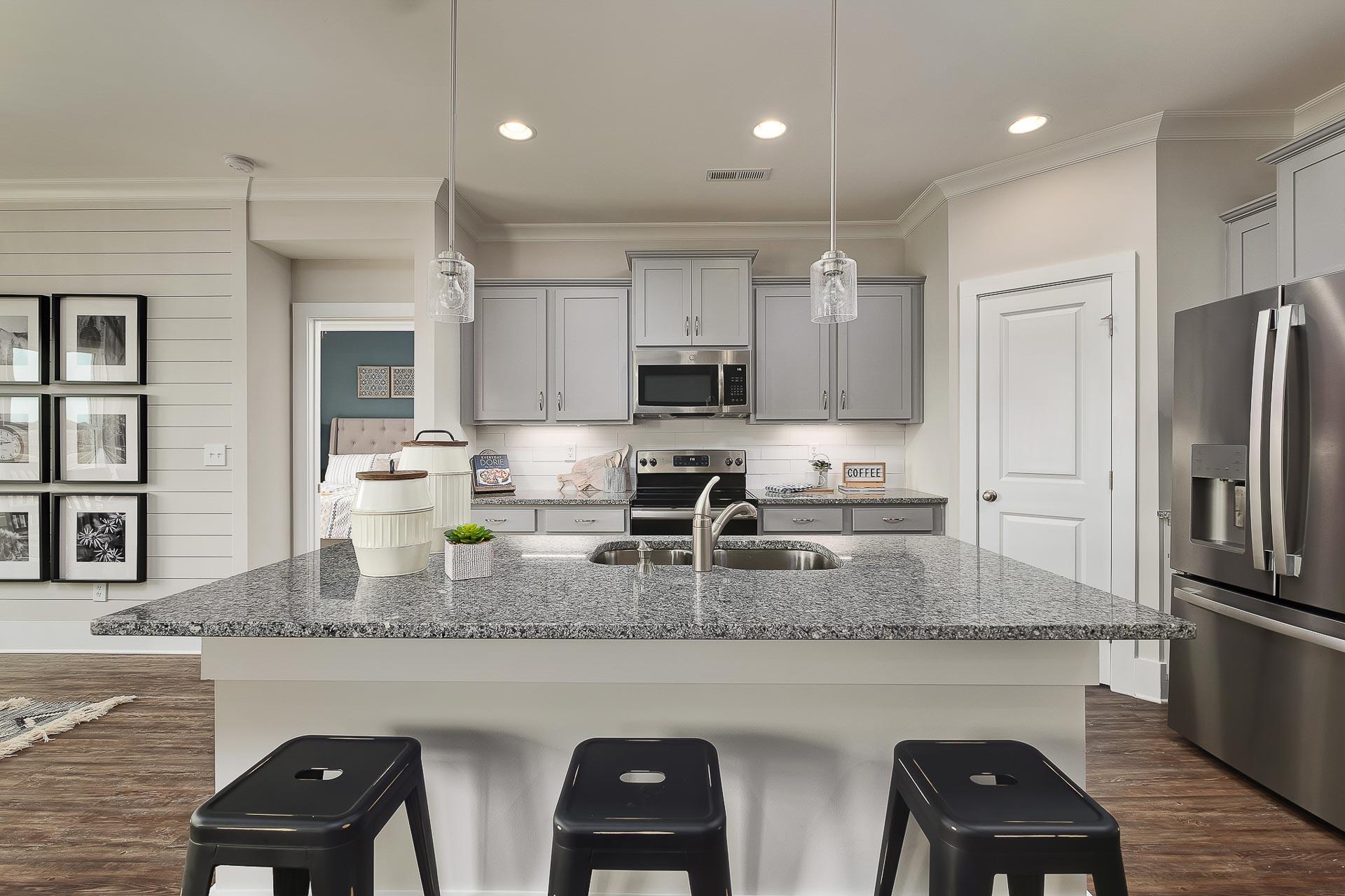kitchen with gray cabinets and stainless steel appliances at The Reserve at North Ridge in Cullman, AL