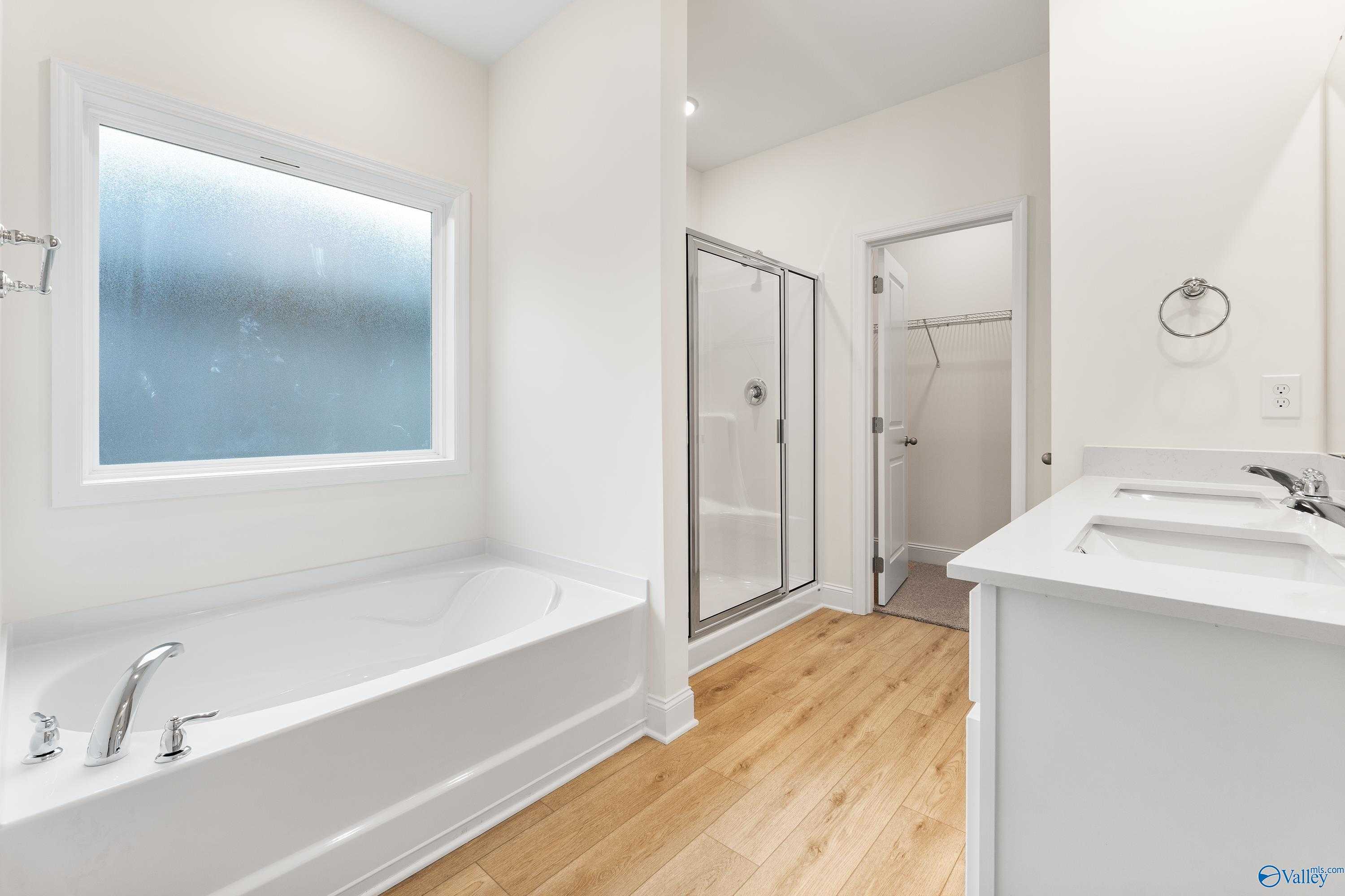 Spacious master bathroom with soaking tub, glass shower enclosure, double vanity in Davidson Homes The Franklin C, Huntsville AL