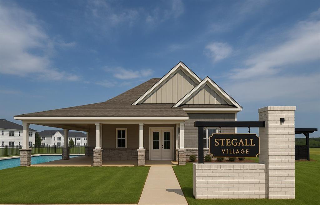 Two-story Monroe A home by Davidson Homes in Stegall Village, Emerson, GA, with covered porch and welcome sign