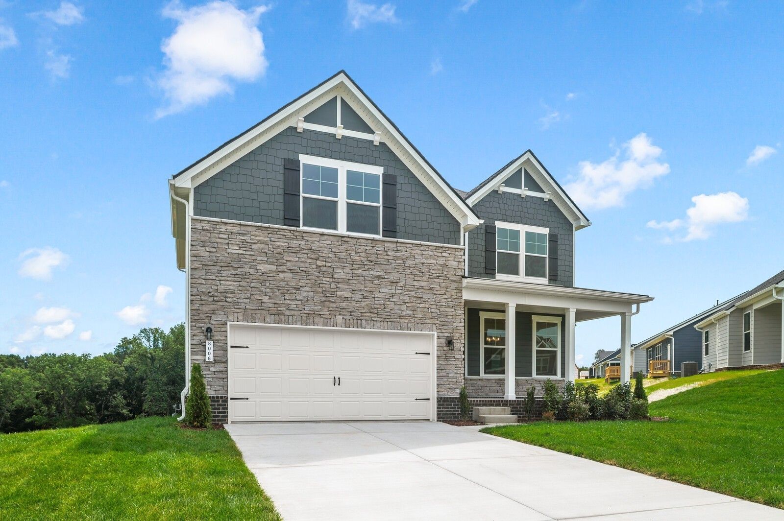 Two-story Willow floor plan home by Davidson Homes with stone exterior and 2-car garage in Calista Farms, White House, TN.