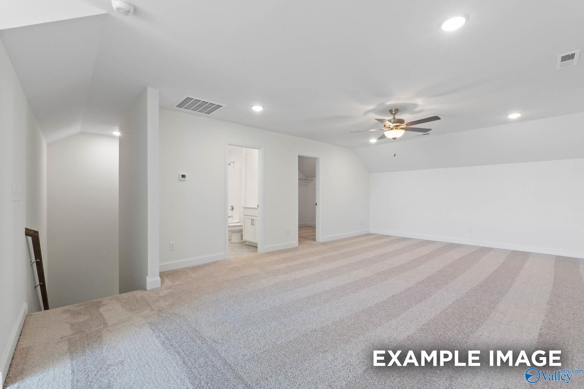 Spacious carpeted bonus room in The Rockford B floor plan by Davidson Homes at Kendall Downs in Toney, Alabama.