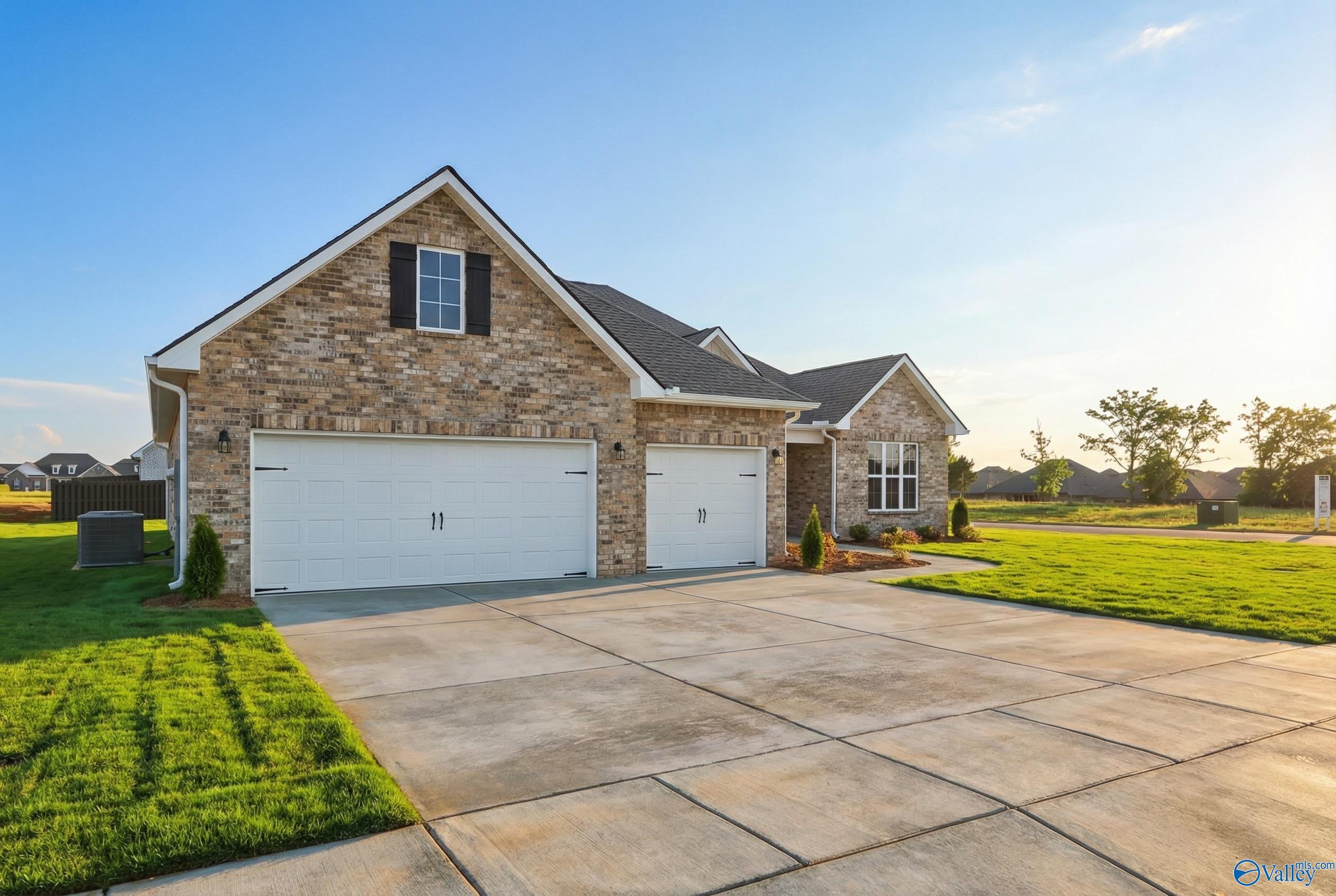 Brick 1-story home with 2-car garage, driveway, and lush green lawn in Briercreek, Meridianville, Alabama - Davidson Homes The Finleigh