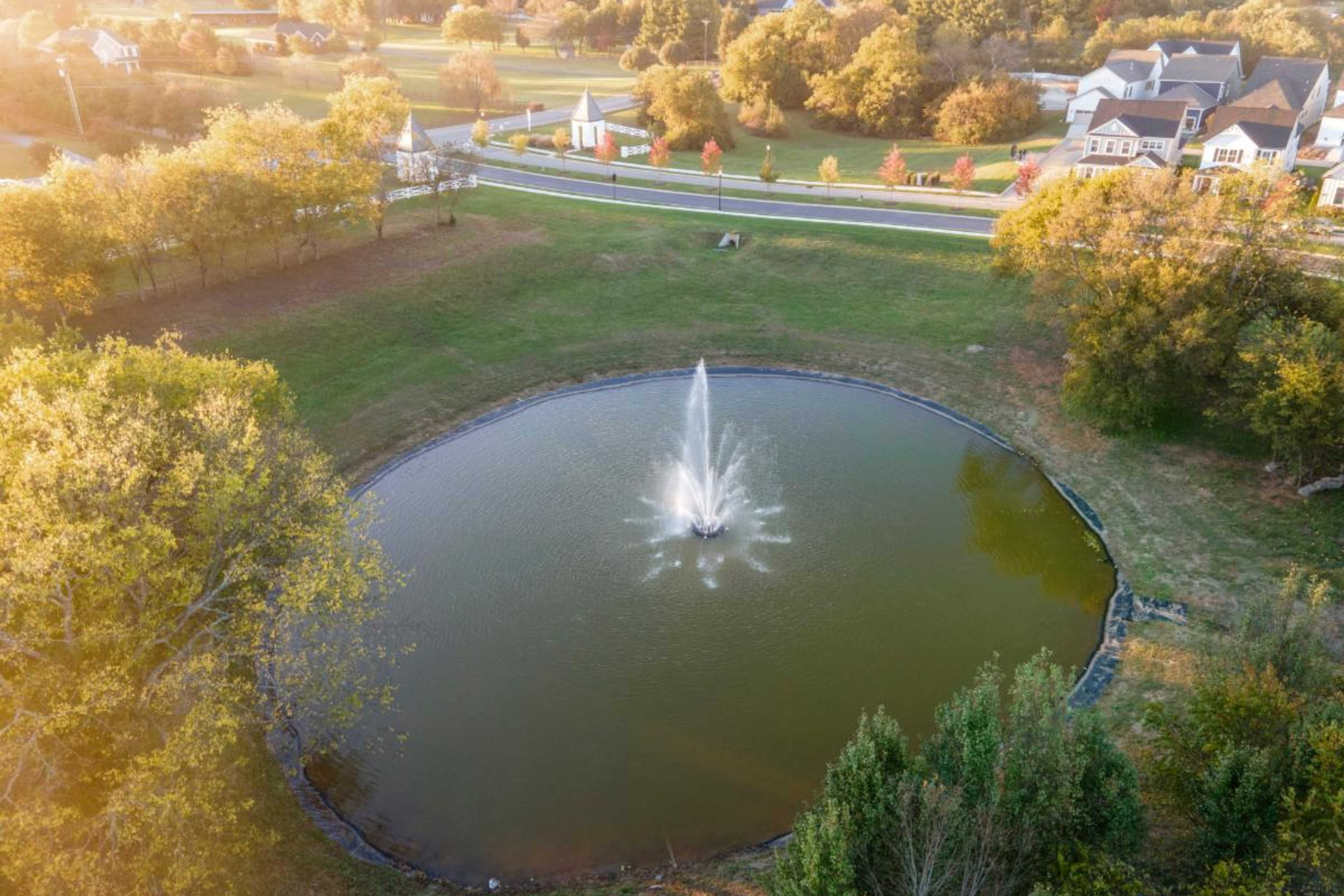 Aerial view of fountain pond in Shelton Square Murfreesboro TN amid autumn trees and Davidson Homes neighborhood