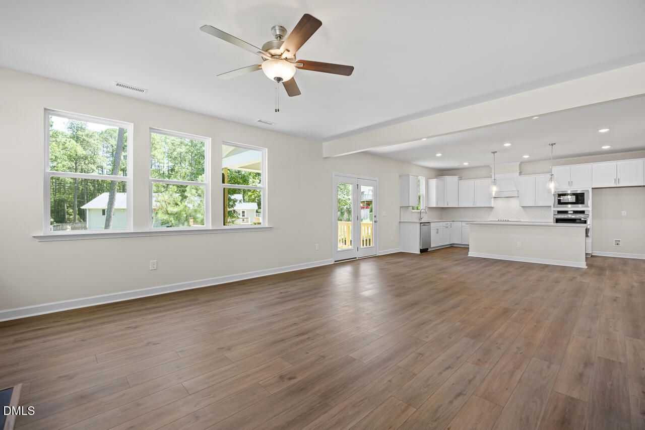Open-concept living room and kitchen with white cabinetry in The Hickory II B floor plan, Montrose, Aberdeen, NC.