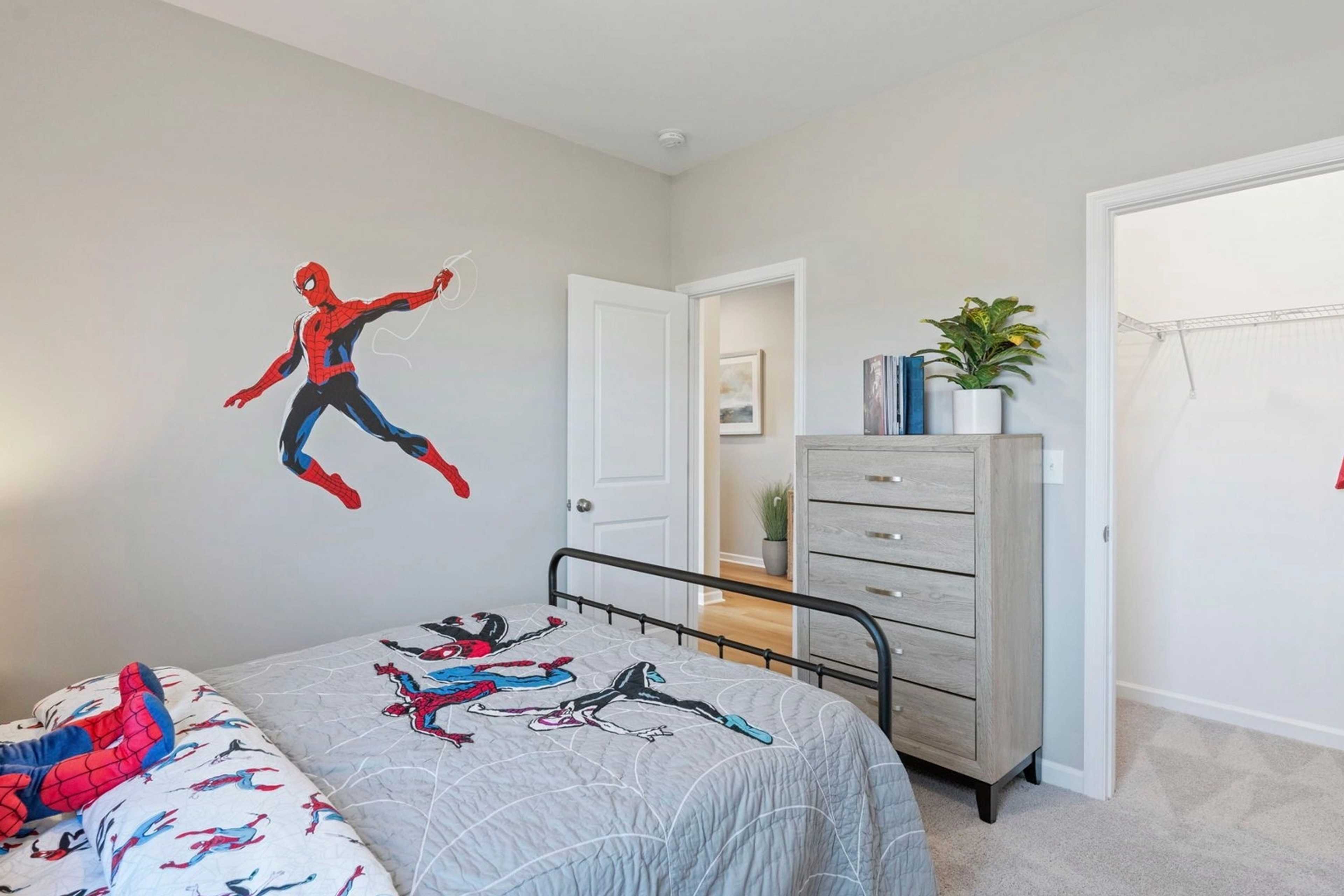 Spider-Man themed children's bedroom in Bailey Park Fayetteville TN with gray walls bed dresser and wall decal