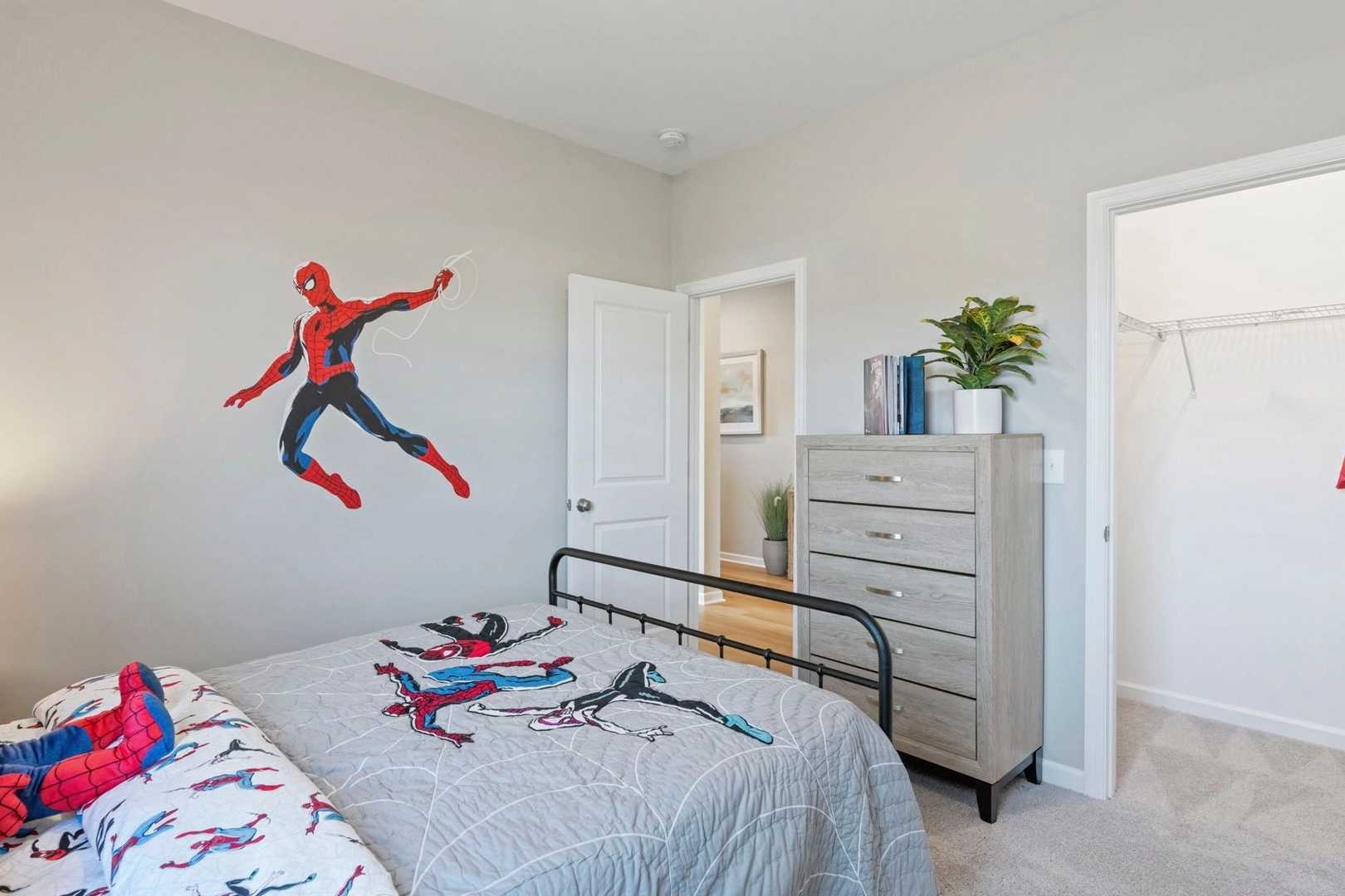 Spider-Man themed children's bedroom in Bailey Park Fayetteville TN with gray walls bed dresser and wall decal
